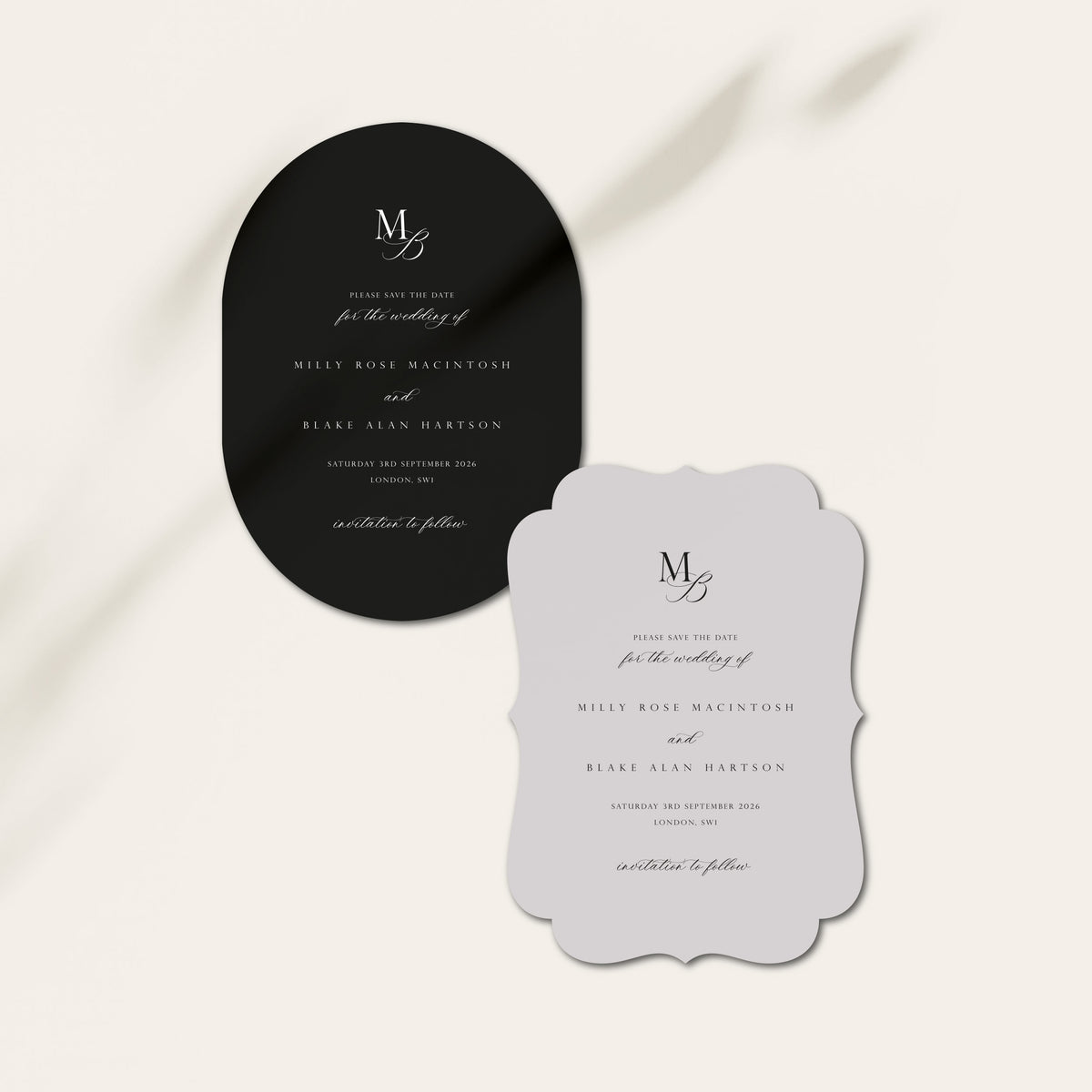 Two wedding save the date cards featuring a black oval card and a scalloped light grey card with elegant serif typography, displayed on a warm off-white background with soft diagonal shadows.