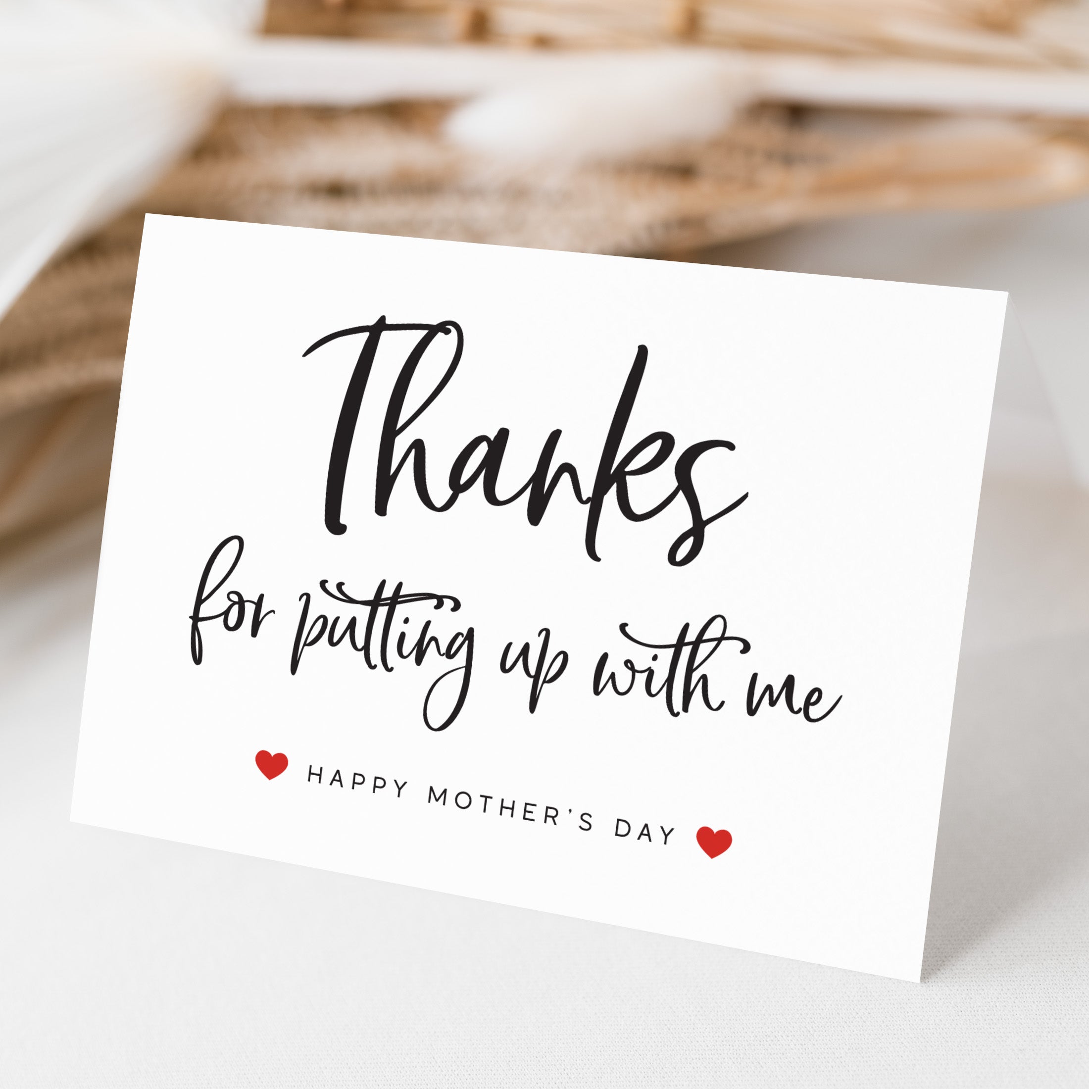 Greeting card with 'Thanks for putting up with me' text on a blurred background