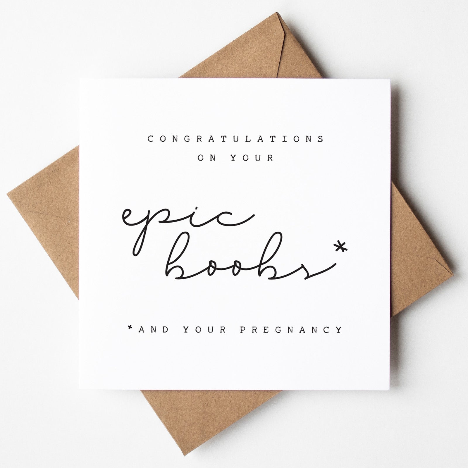 Greeting card with 'Congratulations on your epic boobs and your pregnancy' text on a white background with brown envelope.