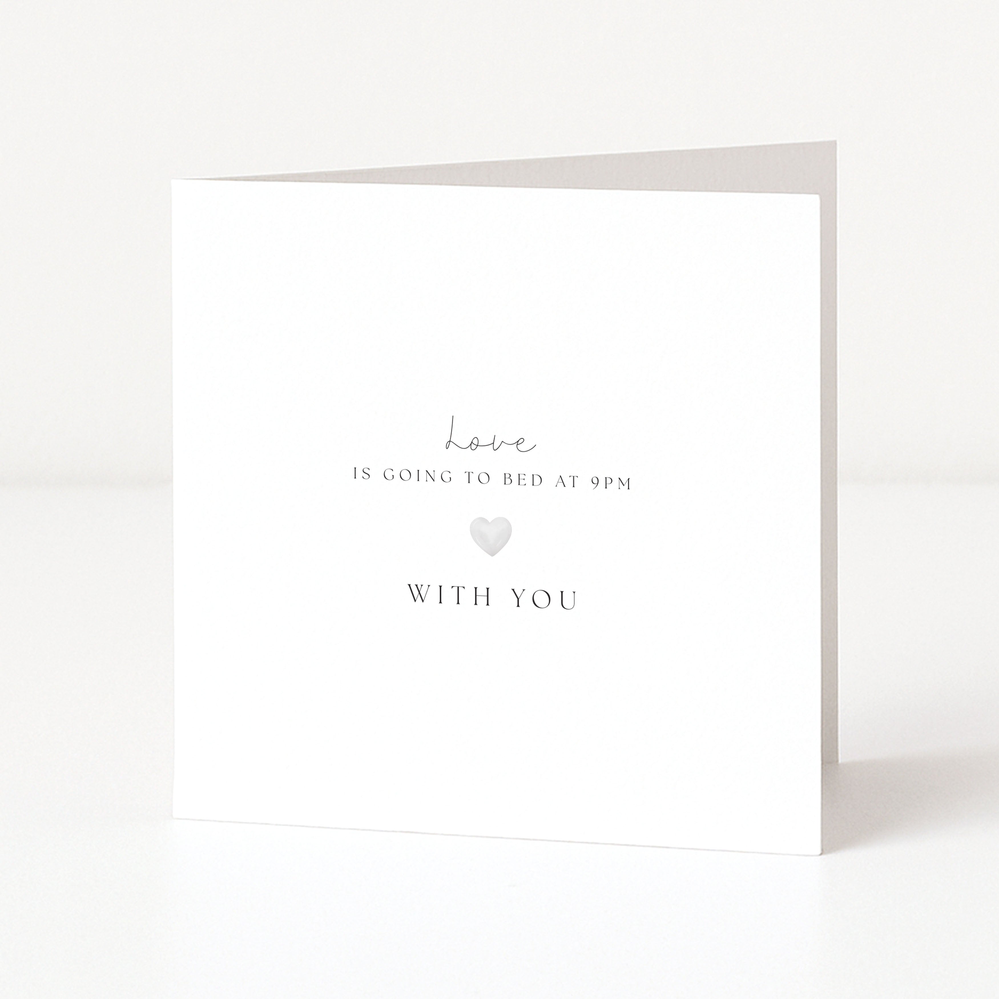 White card with text 'love is going to bed at 9pm with you' on a white background