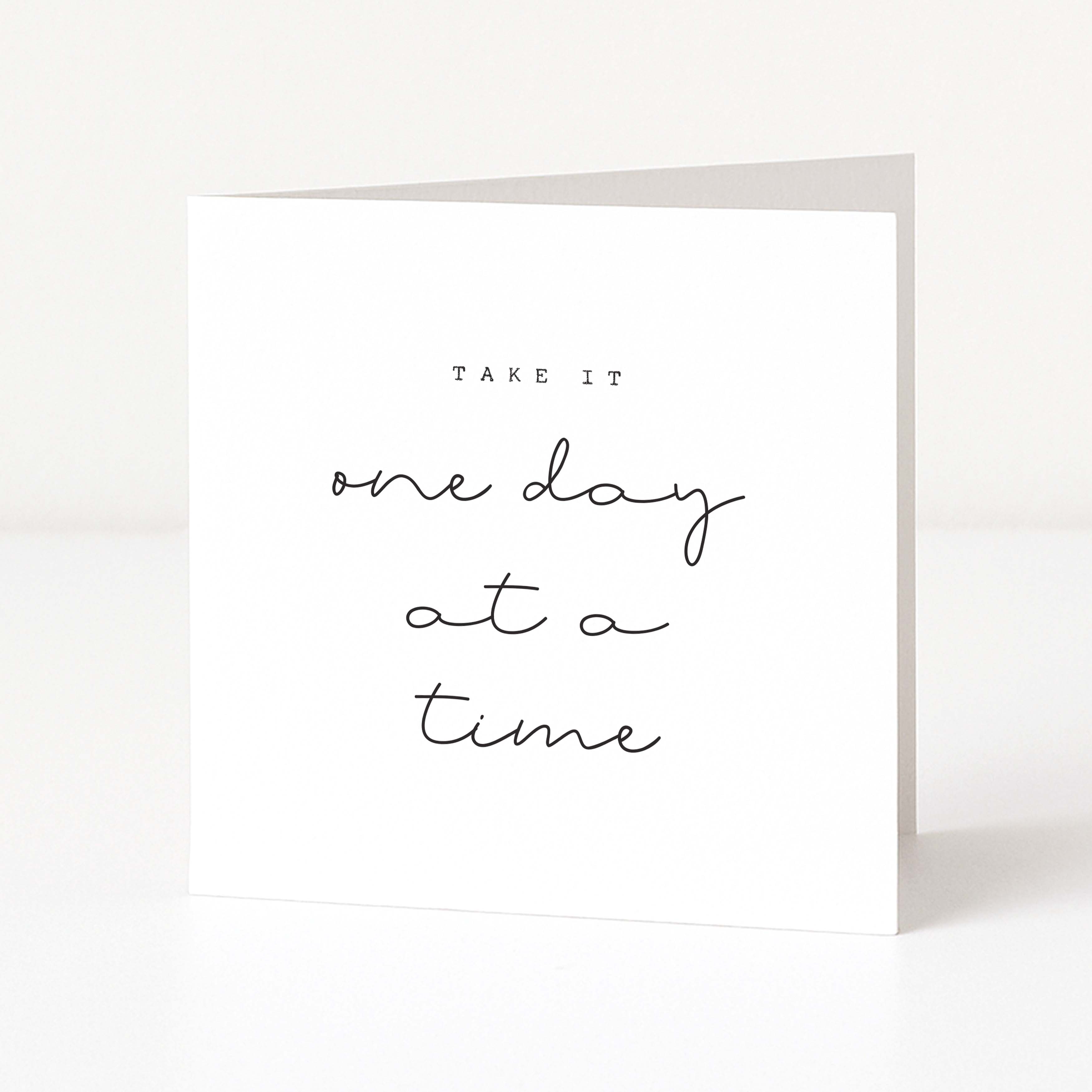 Motivational card with 'Take it one day at a time' text on a white background