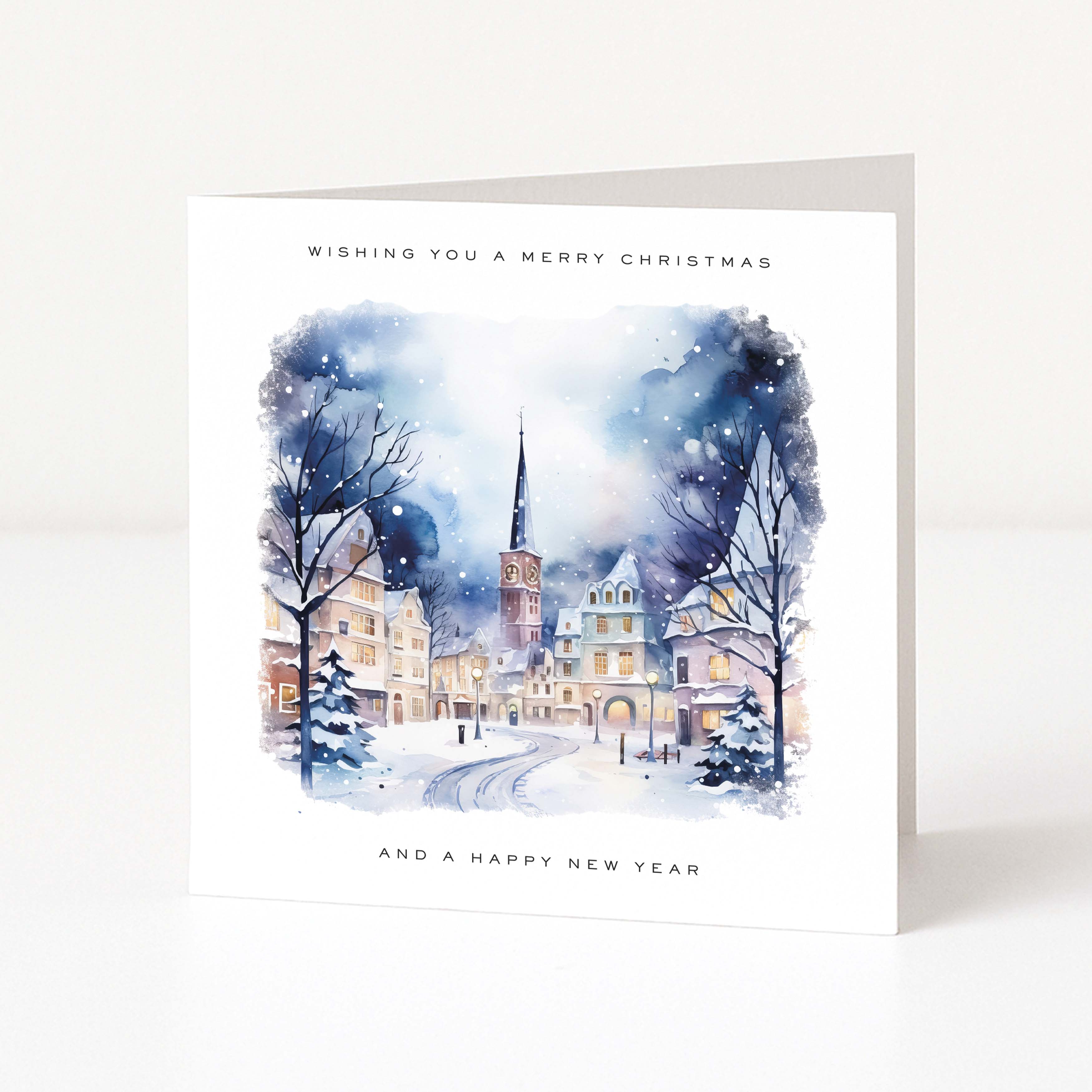 Christmas card with a snowy village scene and text 'Wishing you a Merry Christmas and a Happy New Year' on a white background.