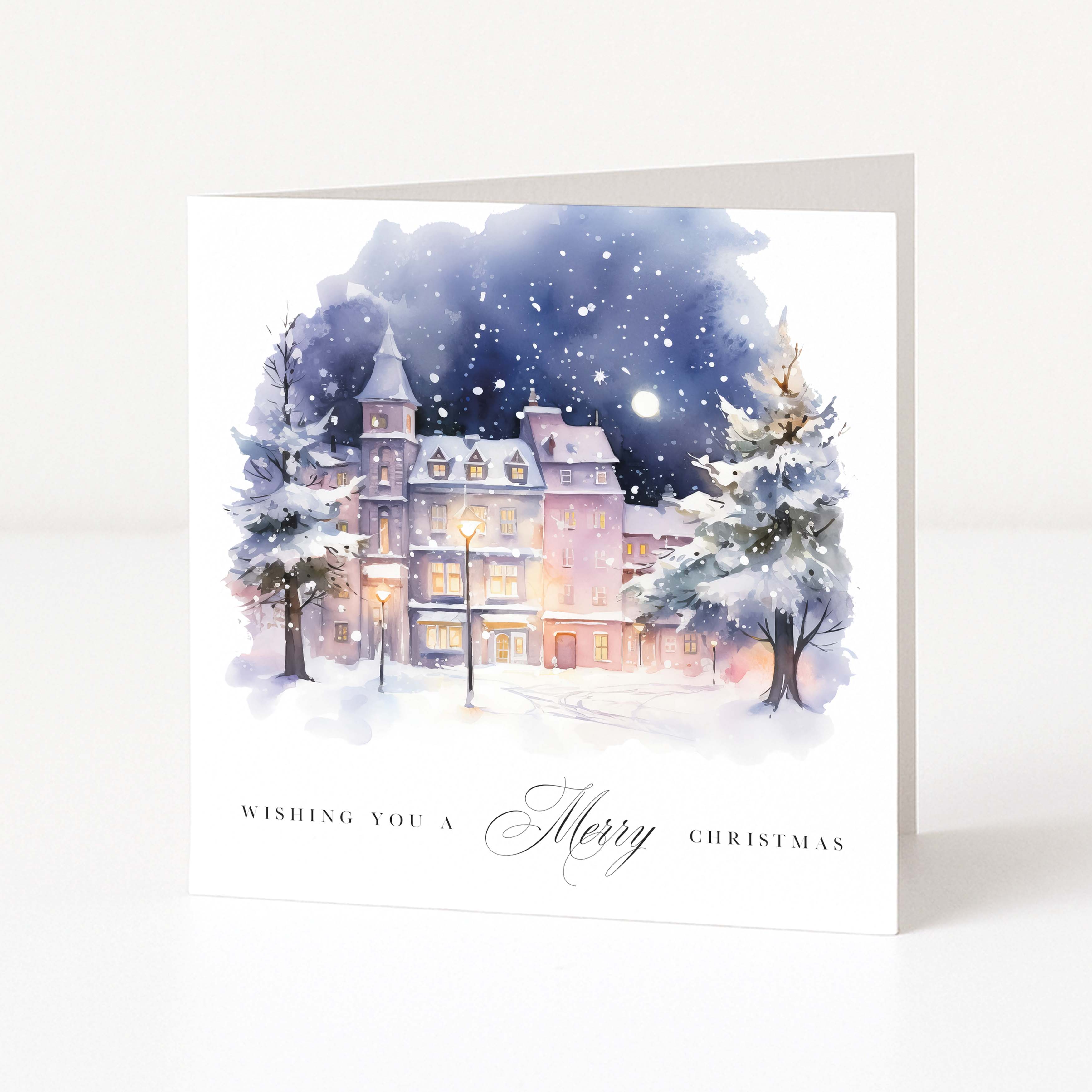 Christmas card with a snowy scene of a house and trees, featuring the text 'Wishing you a Merry Christmas'.