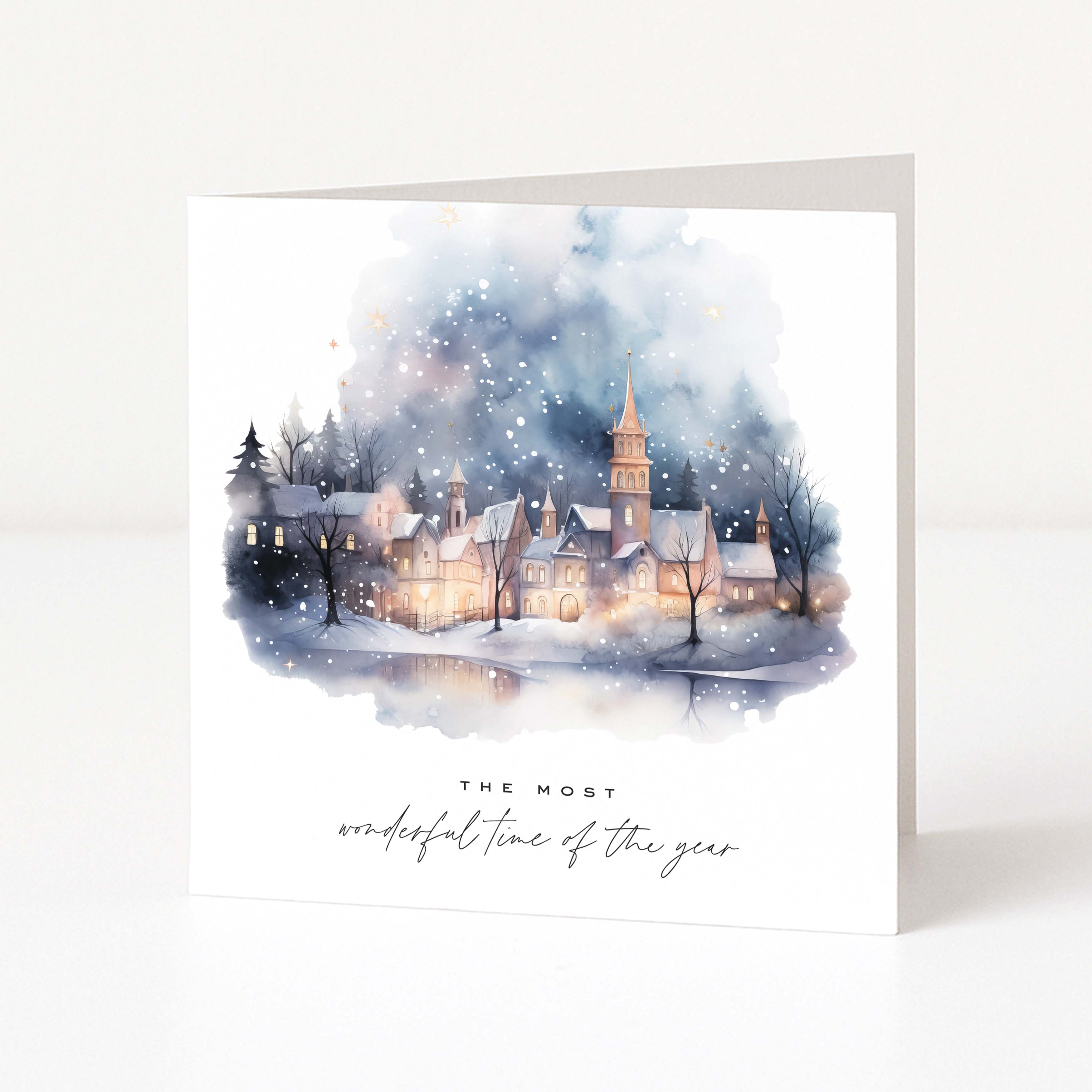 A watercolour Christmas card showing a snowy village scene with "The most wonderful time of the year" text