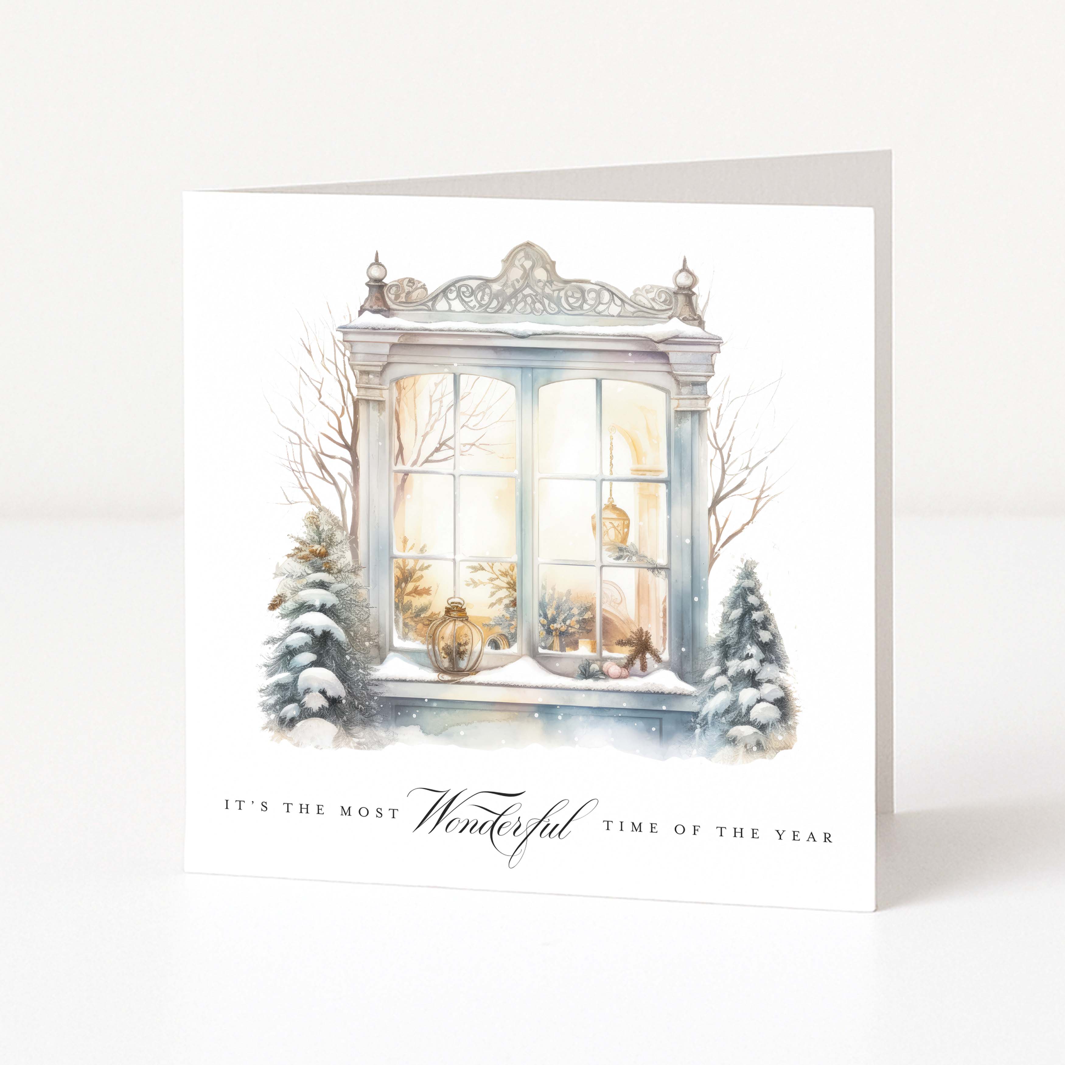 A Christmas card showing a vintage window accompanied with Christmas and snowy artwork features and "It's the most wonderful time of the year" printed underneath.