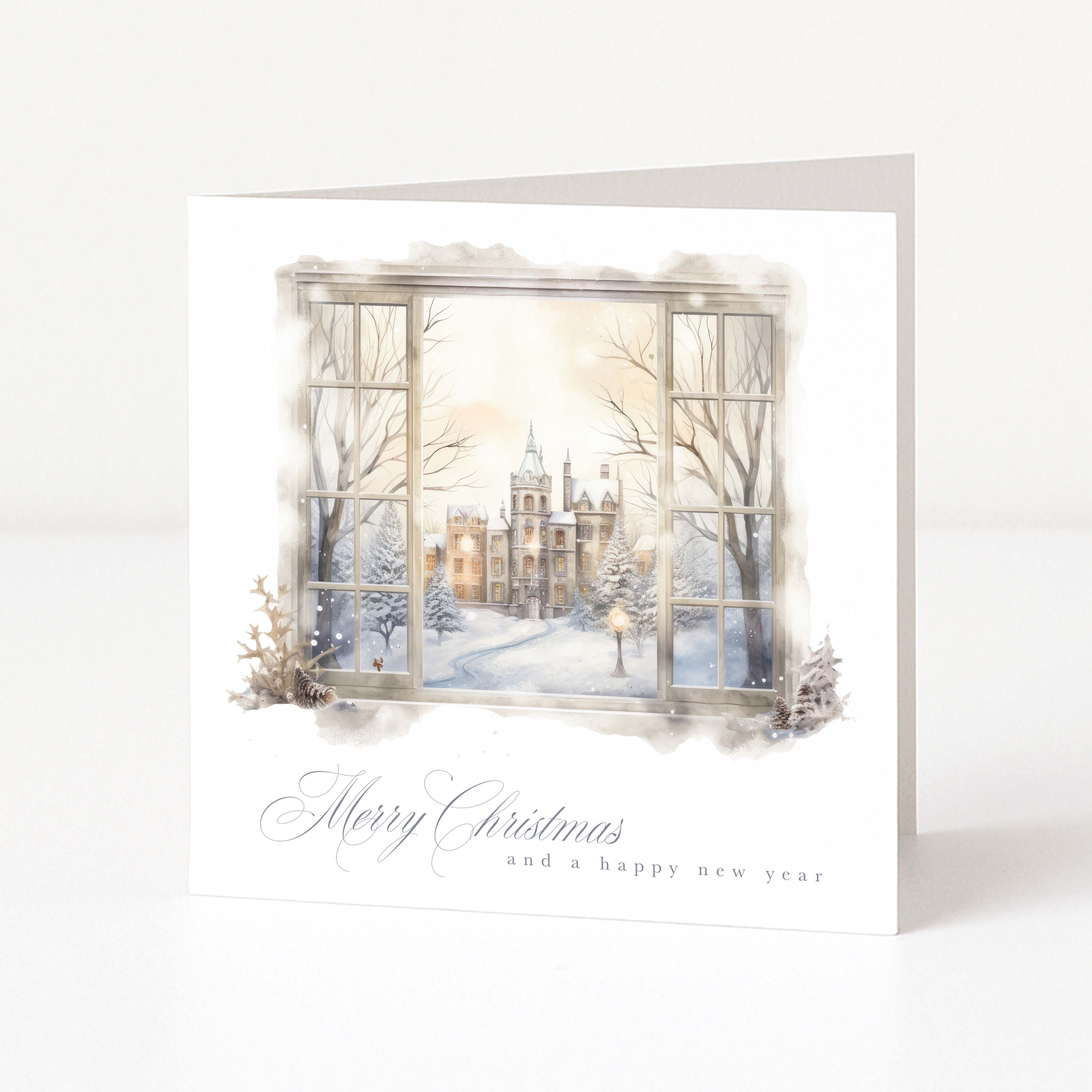A Christmas card with a wintry scene shown through a watercolour window.