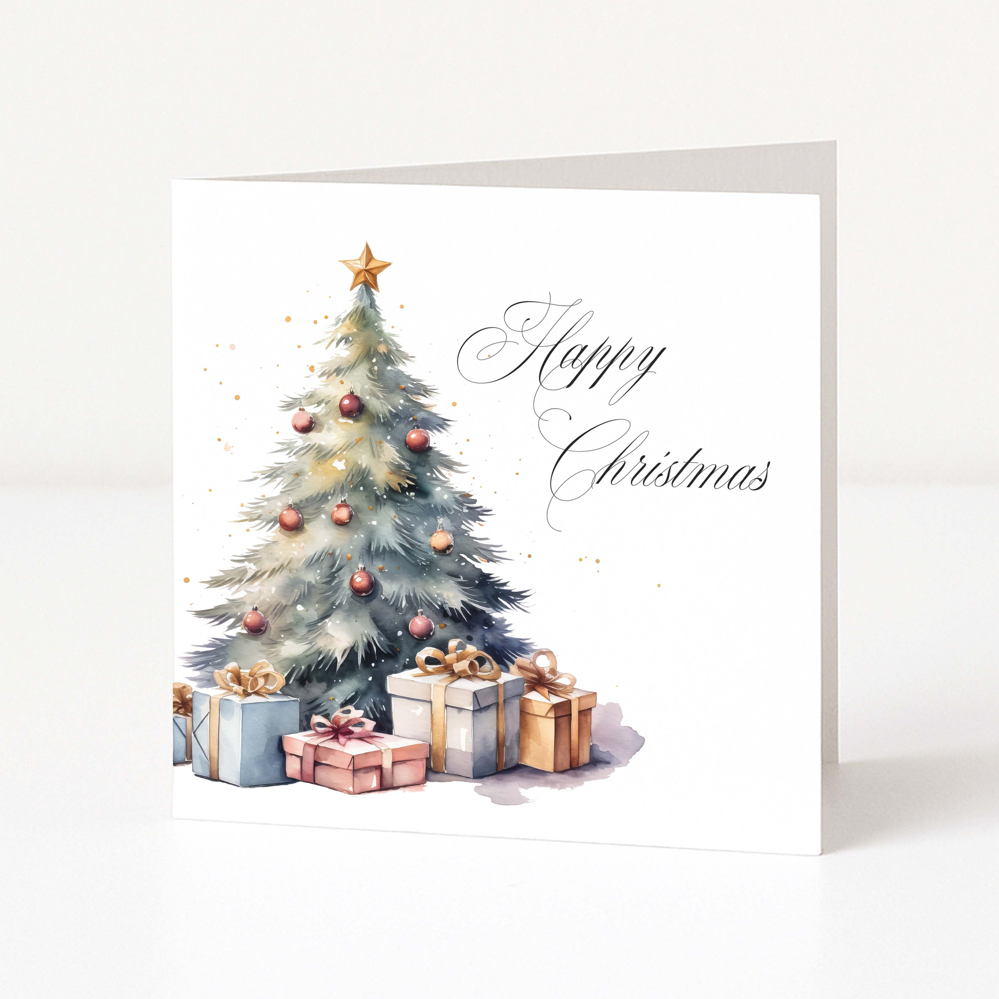 A square Christmas greeting card shown standing upright against a clean white background. The card features a watercolor-style decorated Christmas tree with ornaments, a gold star on top, and several wrapped presents underneath, with the words 'Happy Christmas' in elegant black script on the right.