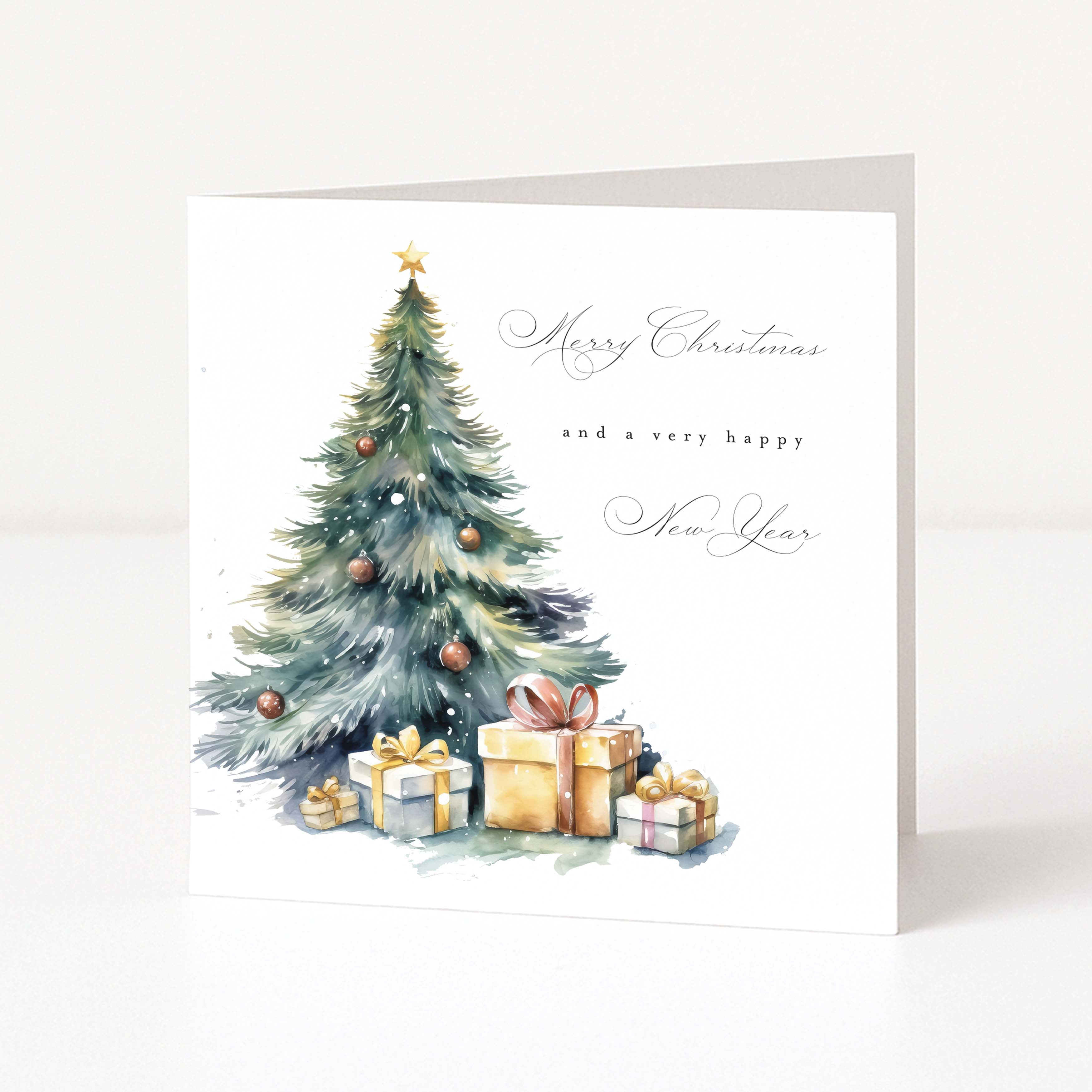 A square Christmas greeting card standing upright on a white surface. The card features a watercolor illustration of a decorated Christmas tree with wrapped gifts at the base and elegant script text reading 'Merry Christmas and a very happy New Year.
