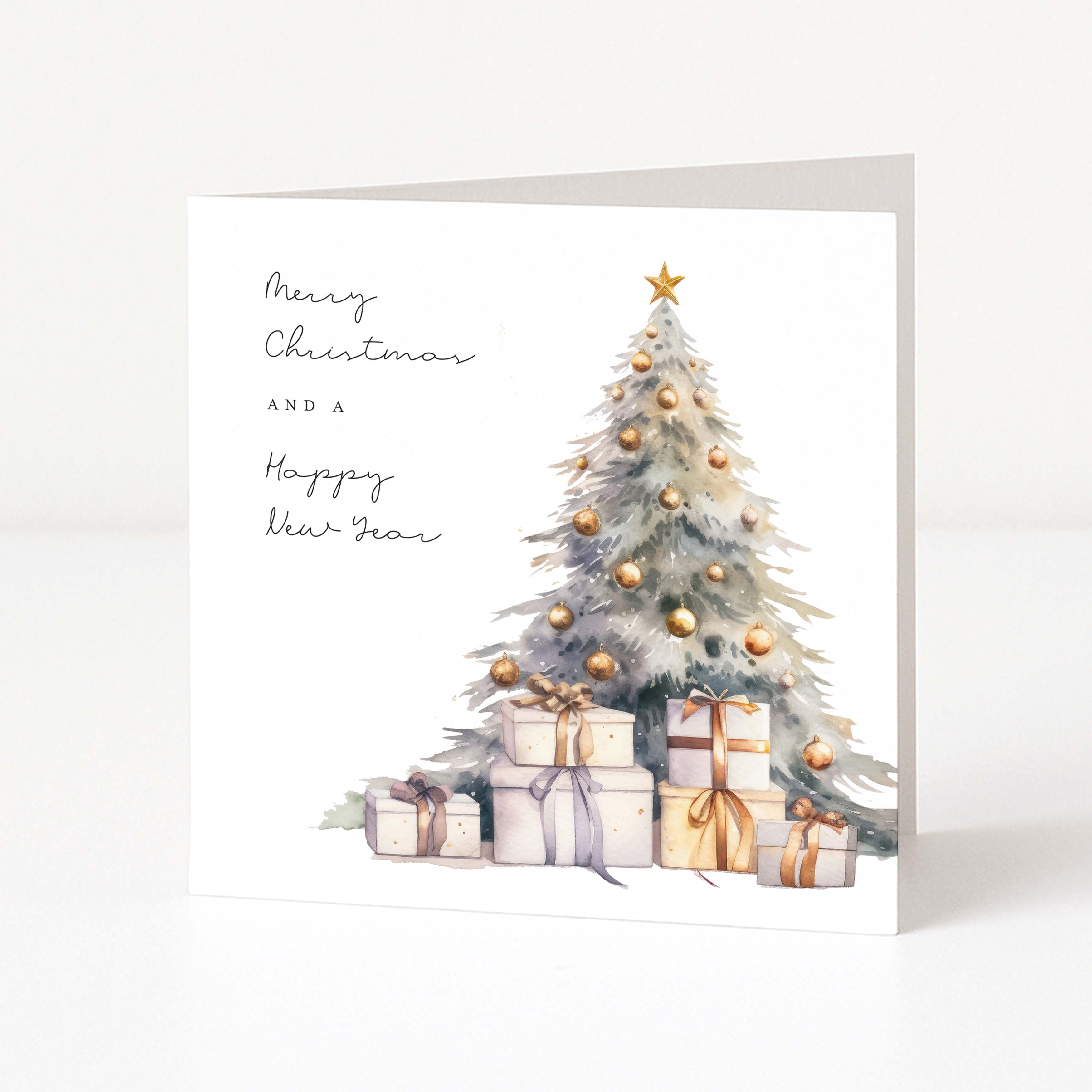A square white Christmas greeting card with a watercolour-style Christmas tree, gold ornaments, wrapped presents, and the text 'Merry Christmas and a Happy New Year,' shown standing against a clean white background.