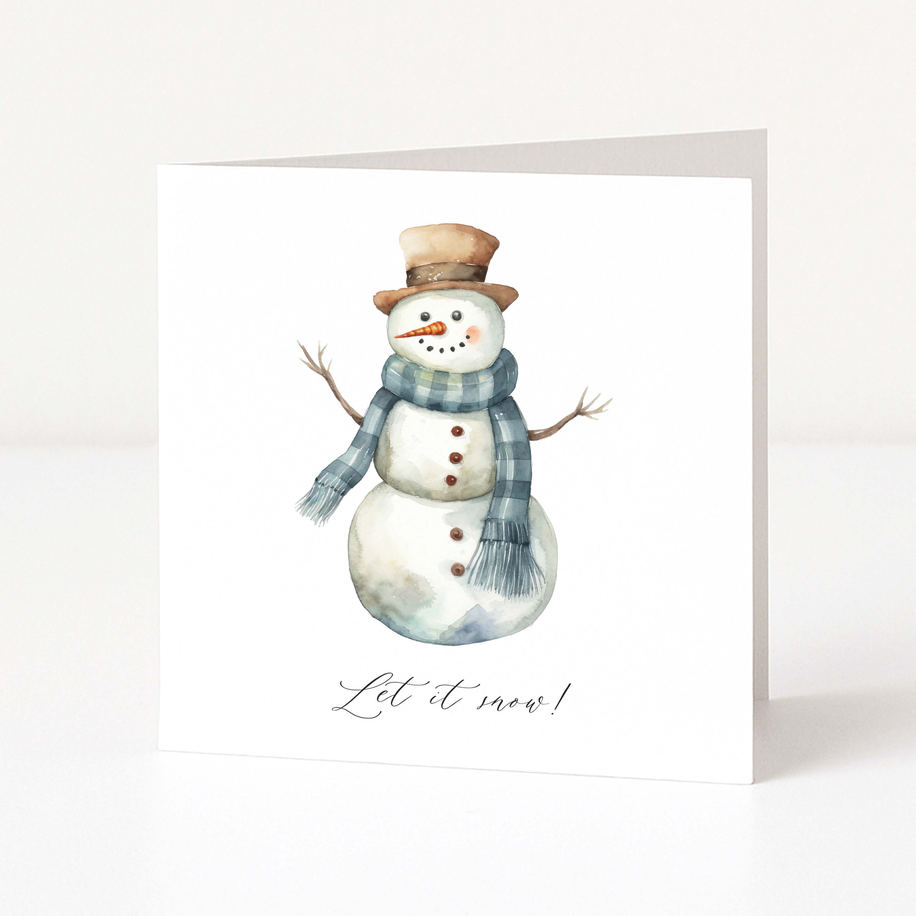 A white Christmas greeting card featuring a watercolour illustration of a snowman wearing a brown top hat and a blue-grey plaid scarf, with the text 'Let it snow!' printed below.