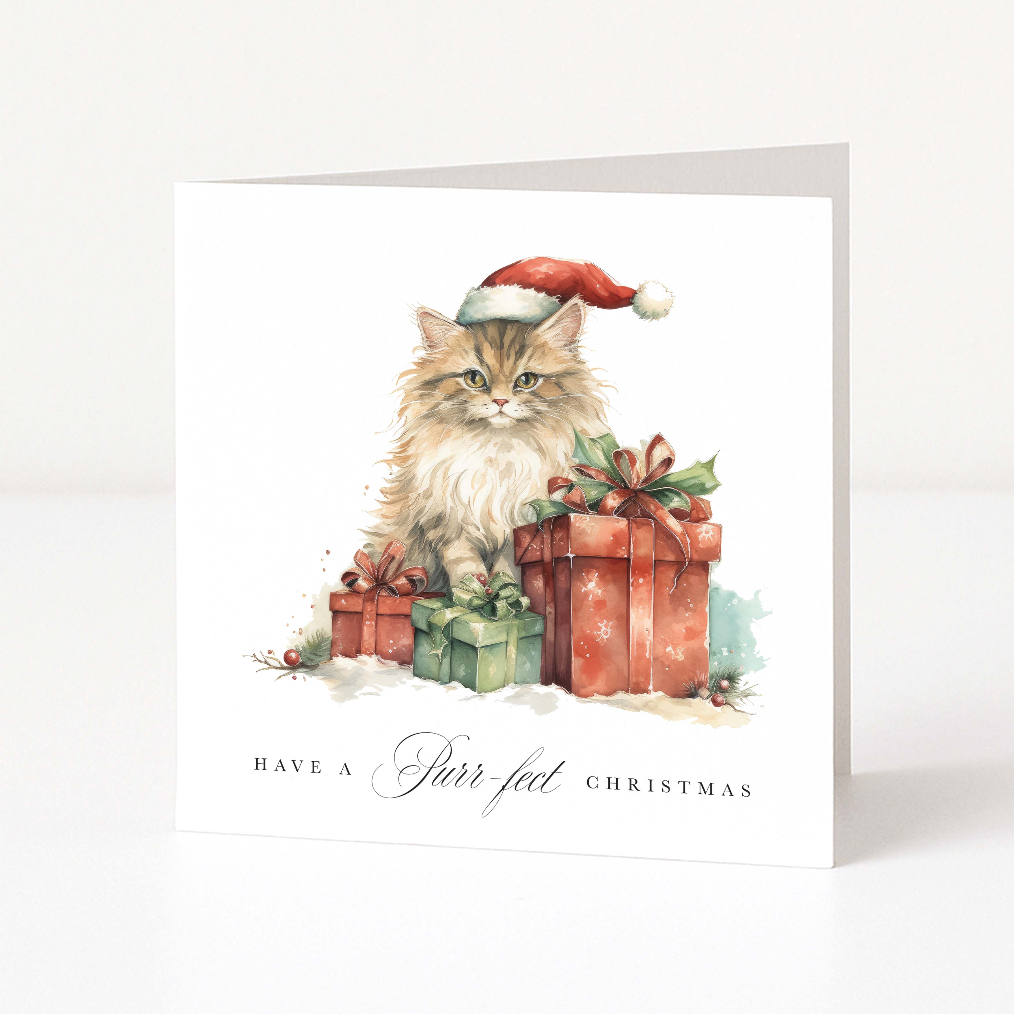 A square Christmas greeting card with a white background featuring an illustration of a fluffy cat wearing a Santa hat beside wrapped Christmas presents. The card reads 'HAVE A Purr-fect CHRISTMAS' at the bottom.