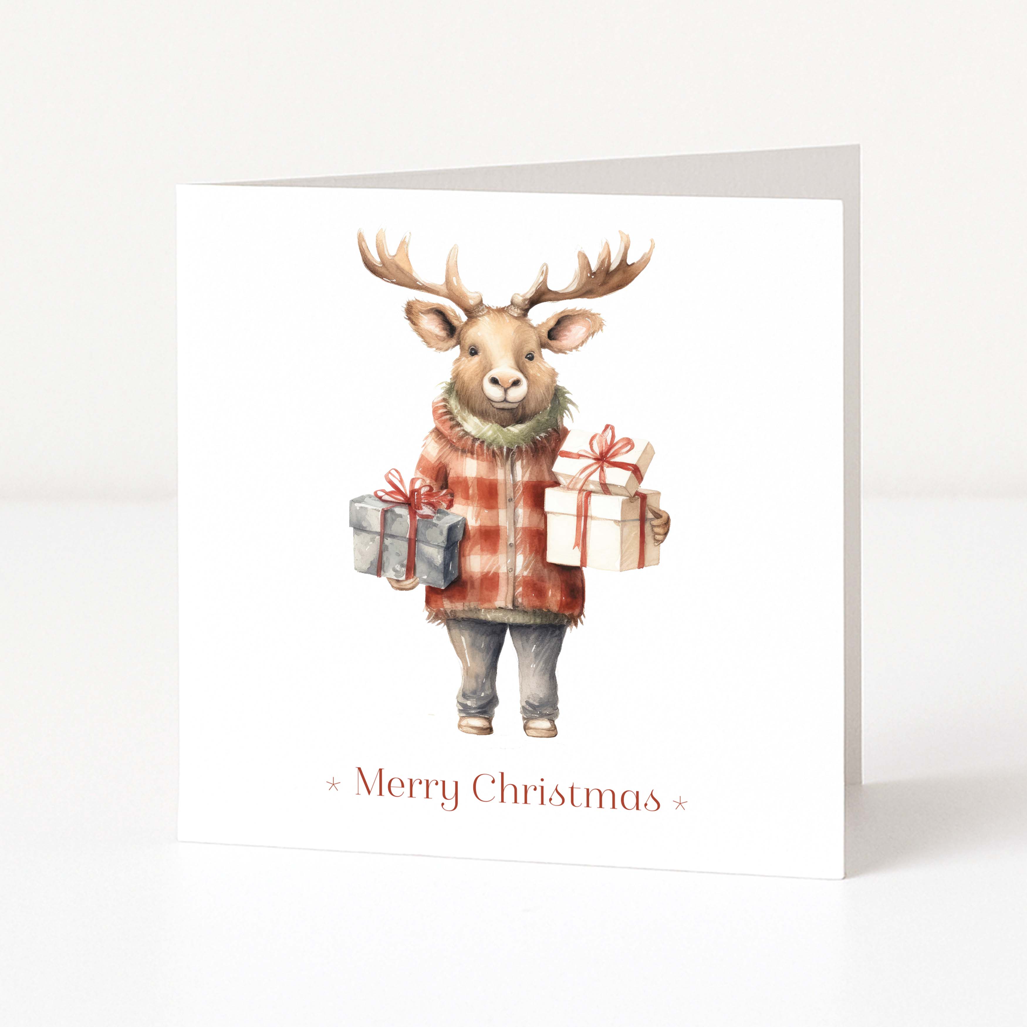A white Christmas greeting card featuring an illustration of a moose wearing a red-and-orange plaid sweater and holding two wrapped presents, with 'Merry Christmas' printed below.