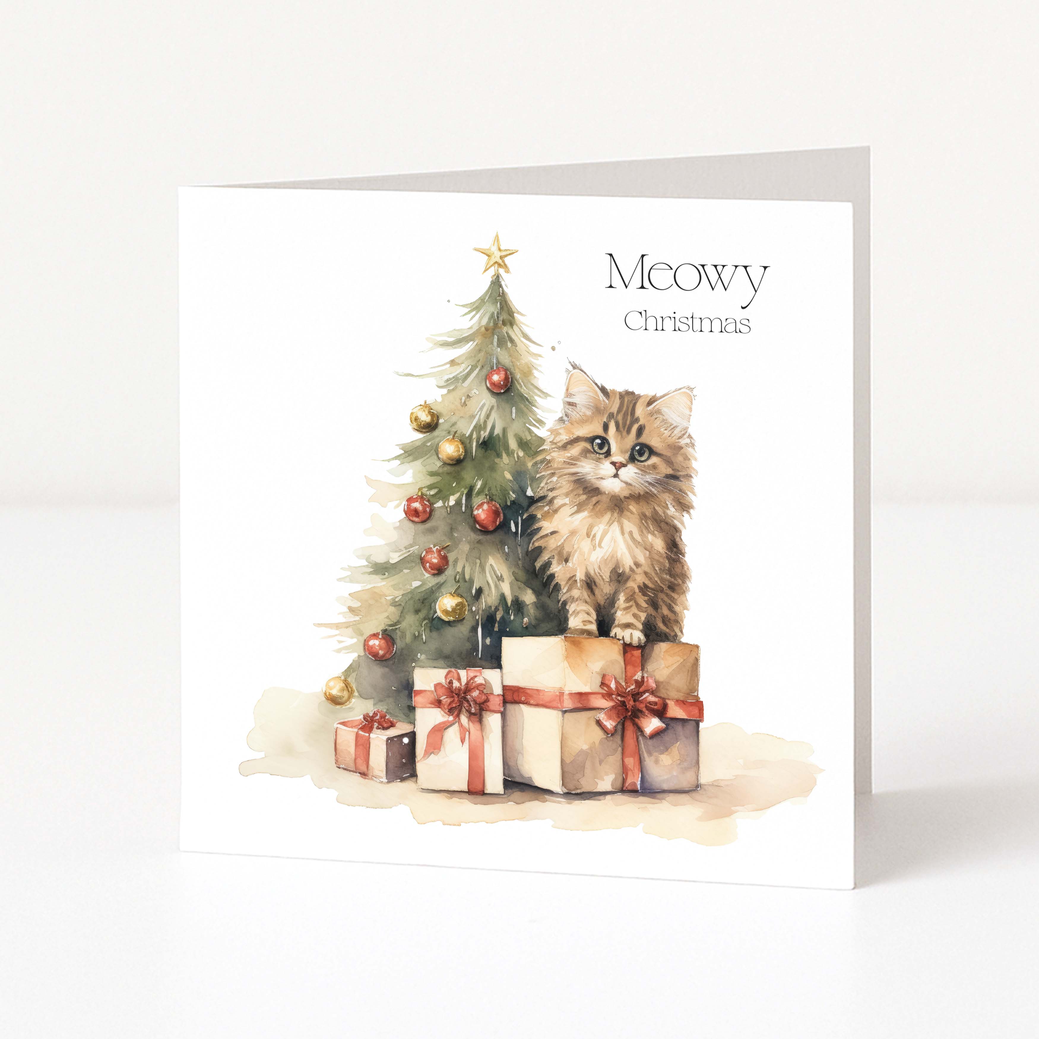 A square greeting card shown standing upright against a clean white background. The card features a watercolour illustration of a fluffy brown cat sitting on wrapped presents beside a decorated Christmas tree, with the text 'Meowy Christmas' printed on the front.