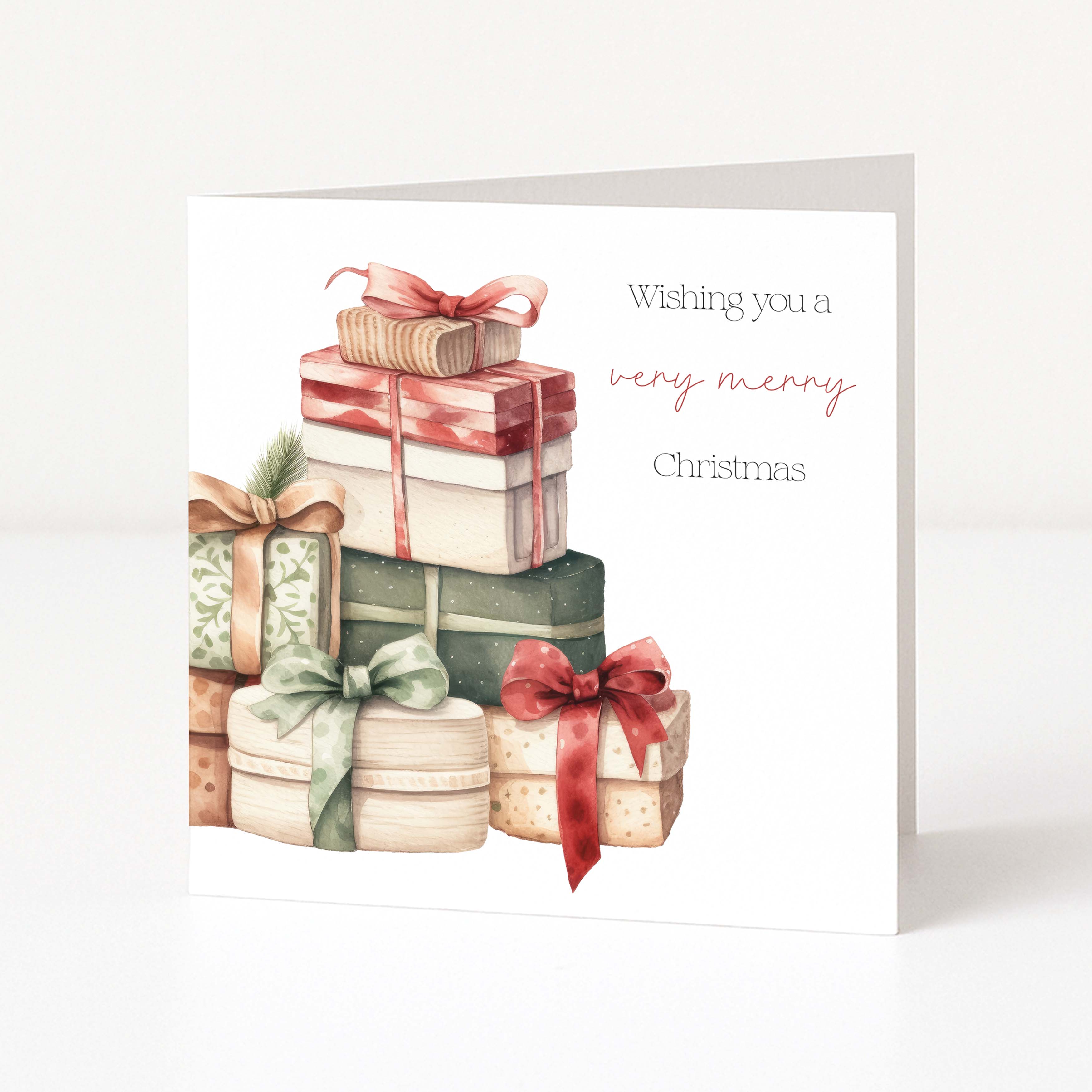 A square Christmas greeting card standing upright on a white surface. The card features an illustration of stacked gift boxes in muted red, green, beige, and brown tones, with the text 'Wishing you a very merry Christmas' printed on the right side.