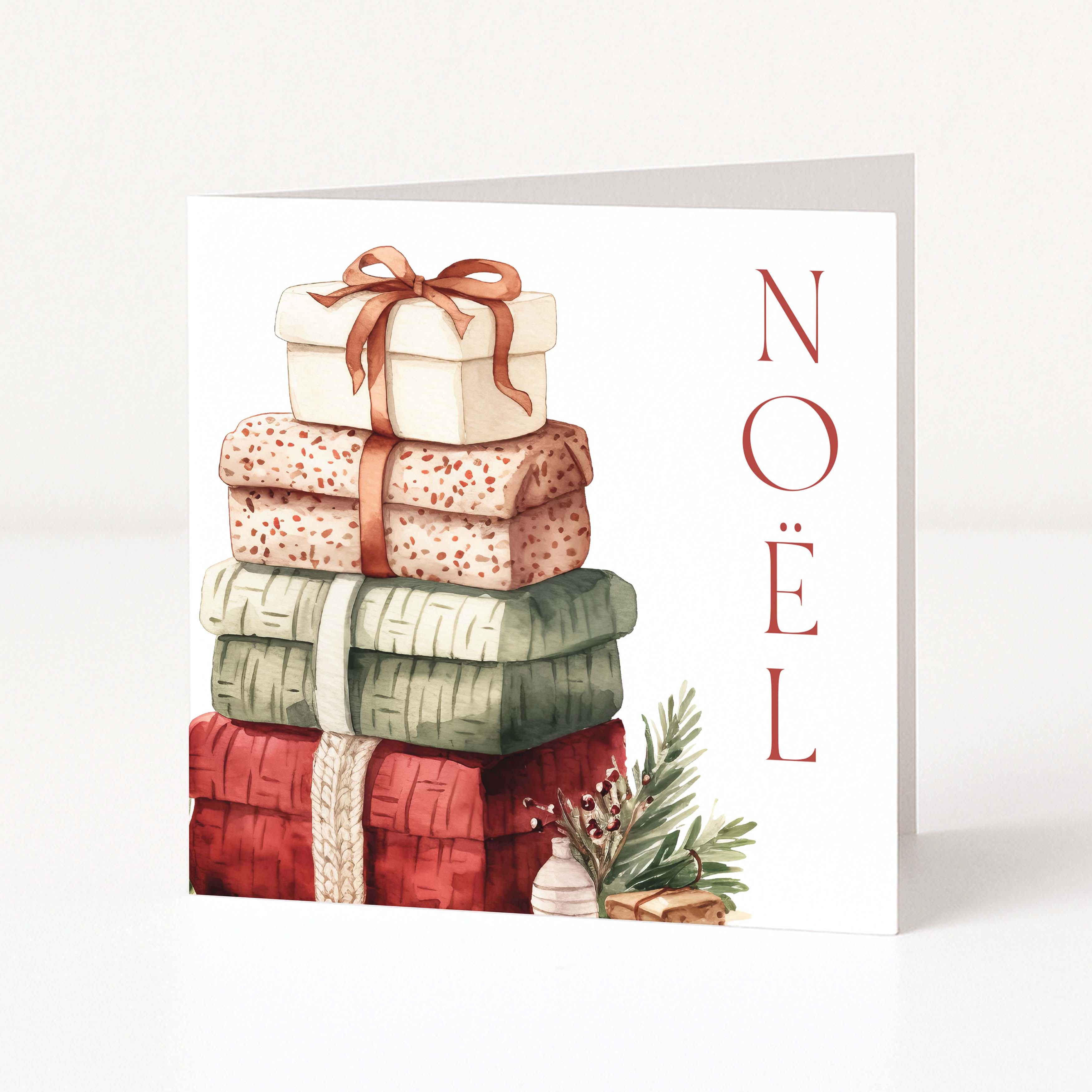 A white Christmas greeting card featuring a watercolour illustration of a stacked pile of four wrapped Christmas presents in cream, rust, beige, sage green, and red. The word 'NOEL' is printed vertically in red serif letters on the right side.