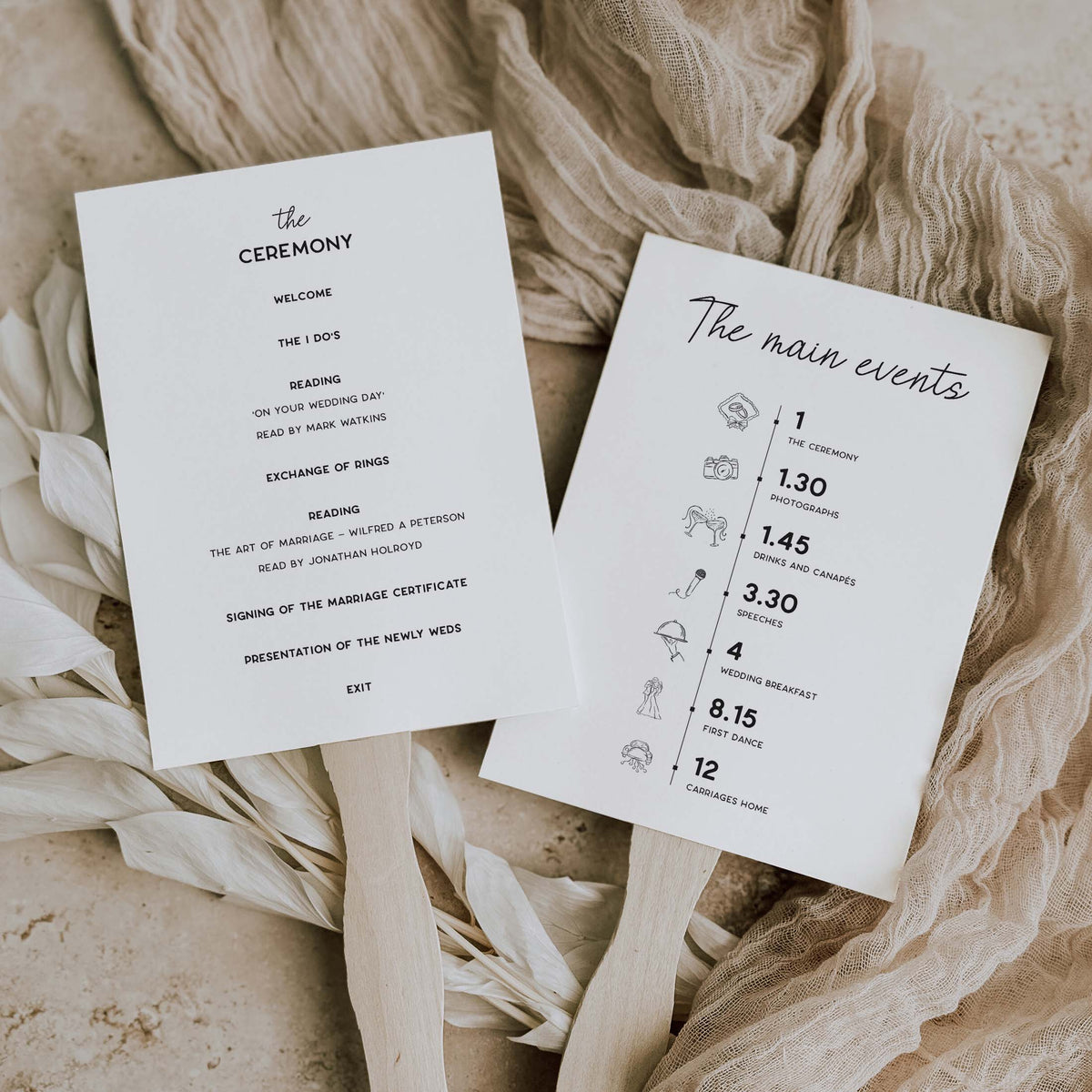 Two printed wedding program cards laid on beige fabric with dried flowers. One card reads 'the CEREMONY' with welcome text, and the other reads 'The main events' with timing icons and notes.