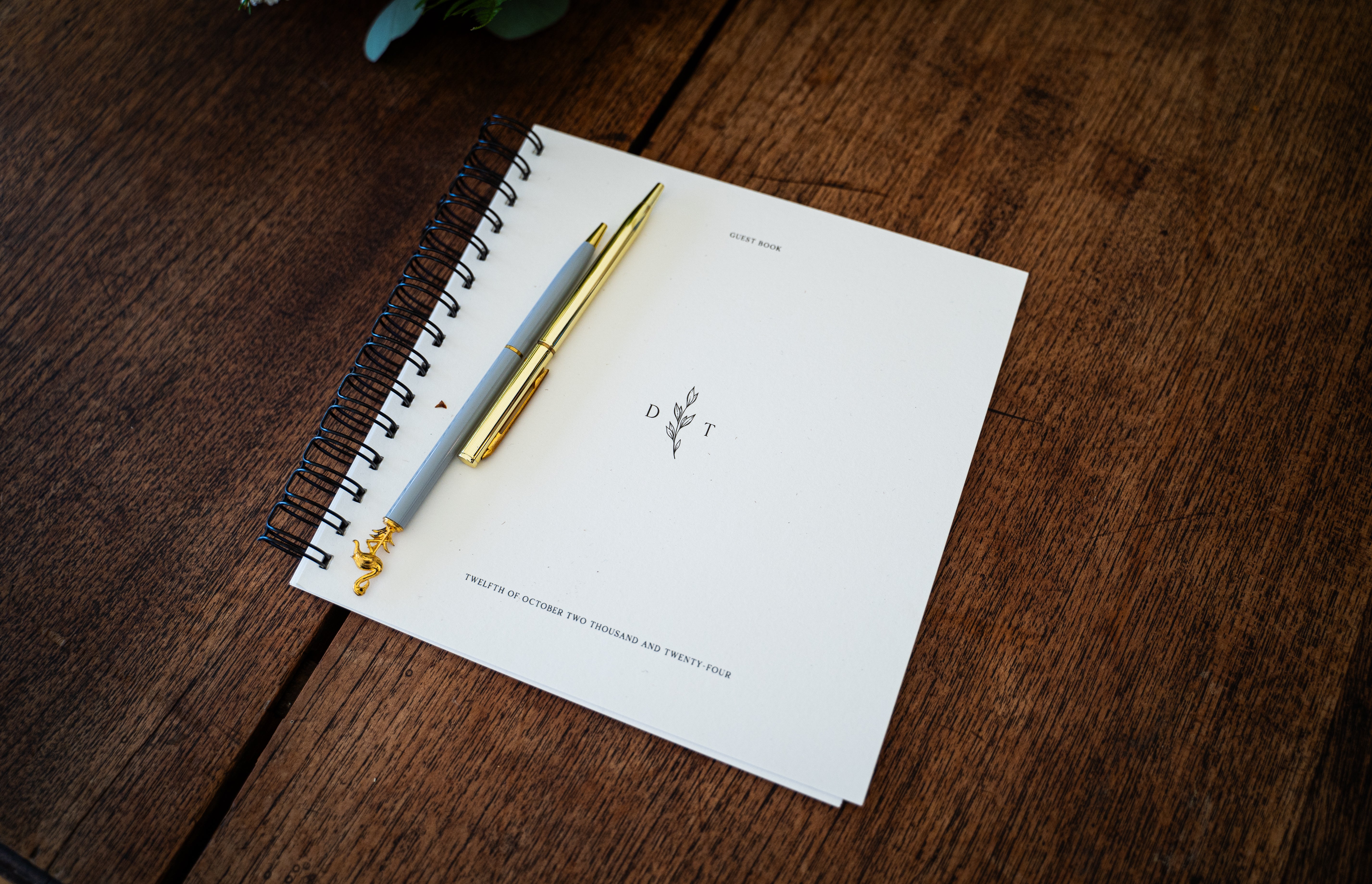 A handmade wedding guest book with decorative pens