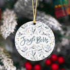 Decorative Christmas ornament with 'Jingle Bells' text on a floral patterned background.