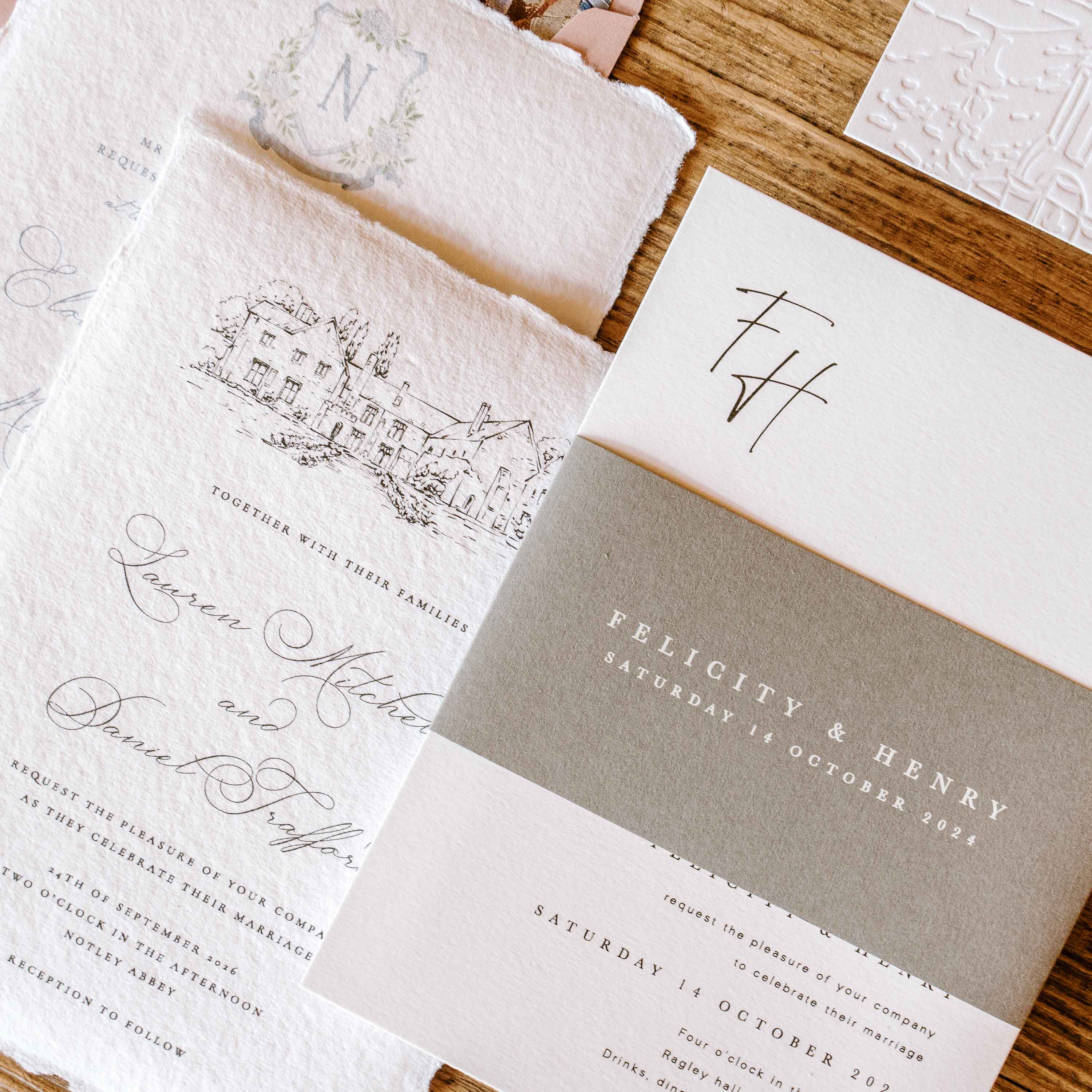 Wedding invitations with elegant designs and text on a wooden surface
