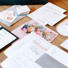 Collection of stationery items including cards and envelopes on a wooden surface.