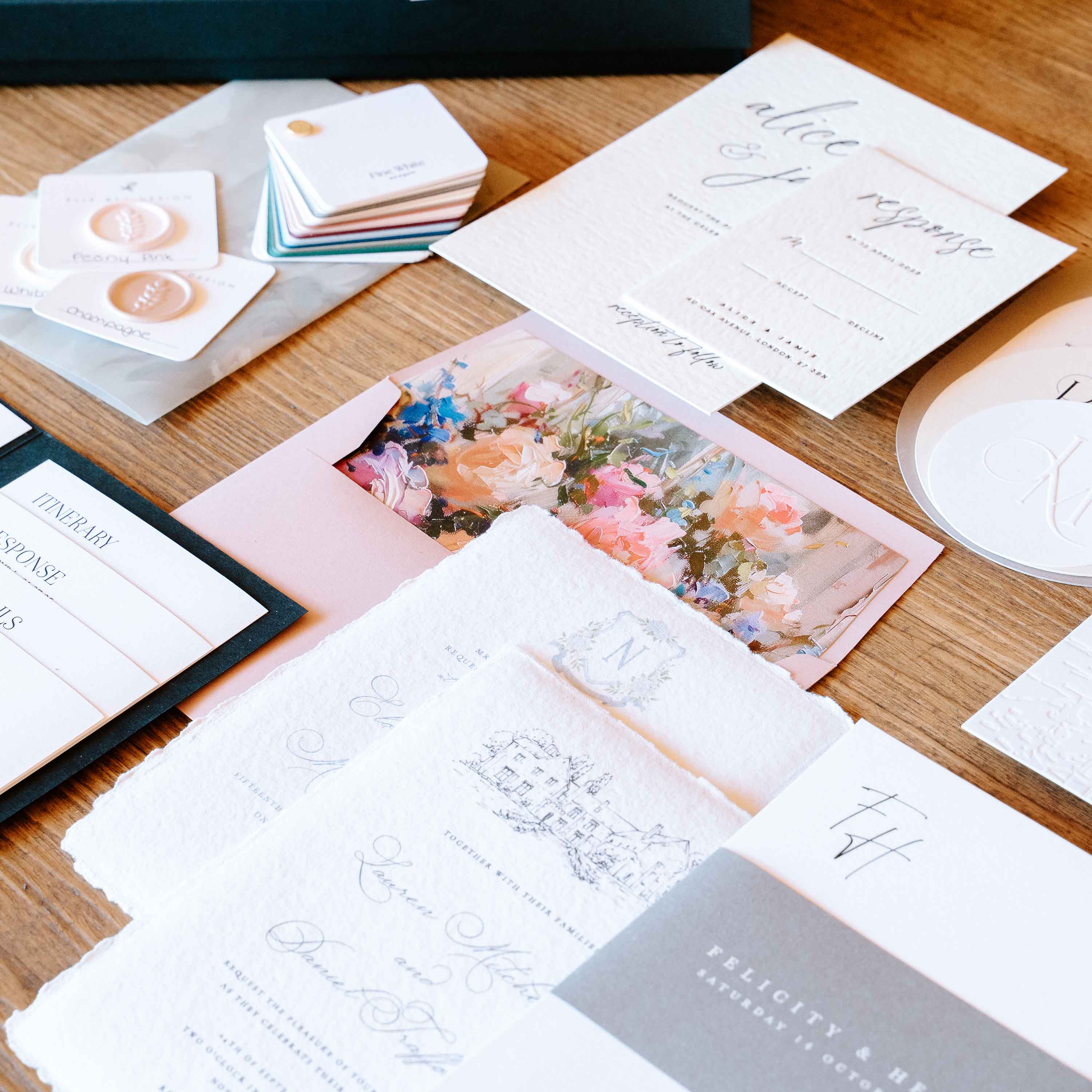 Collection of stationery items including cards and envelopes on a wooden surface.