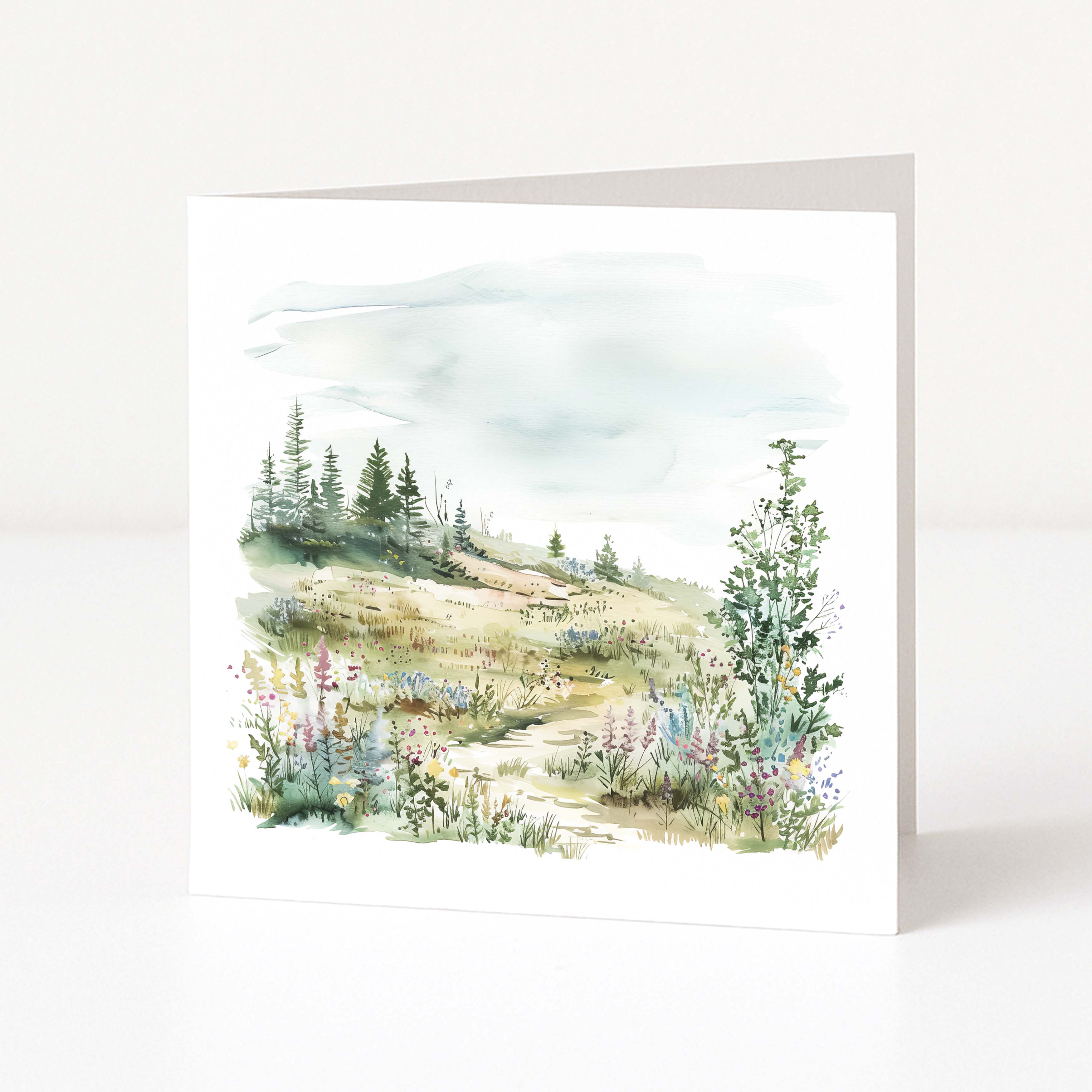 Greeting card with a scenic illustration of a forest and mountains on a white background