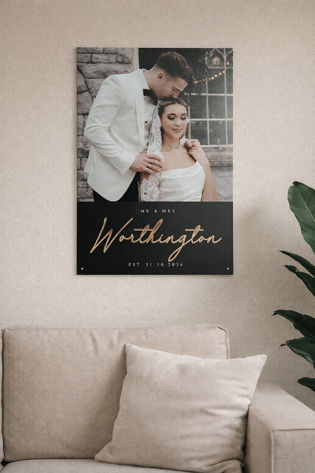 Wall art with a couple and text on a beige wall above a sofa.