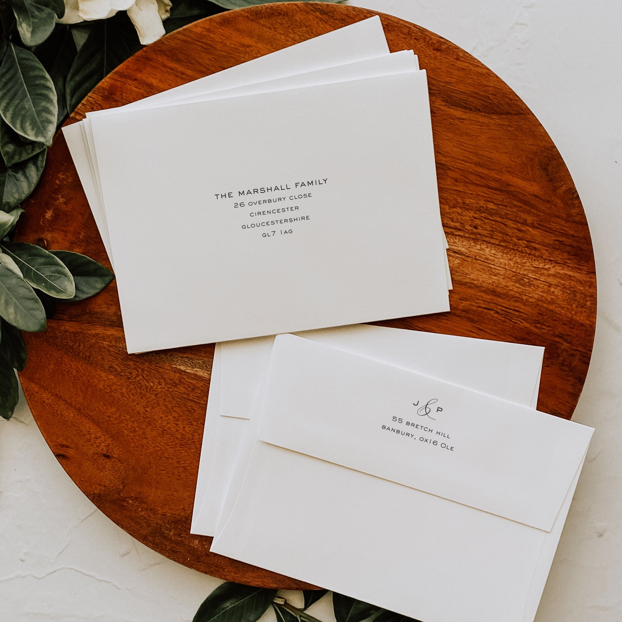 White envelopes with printed text on a wooden surface