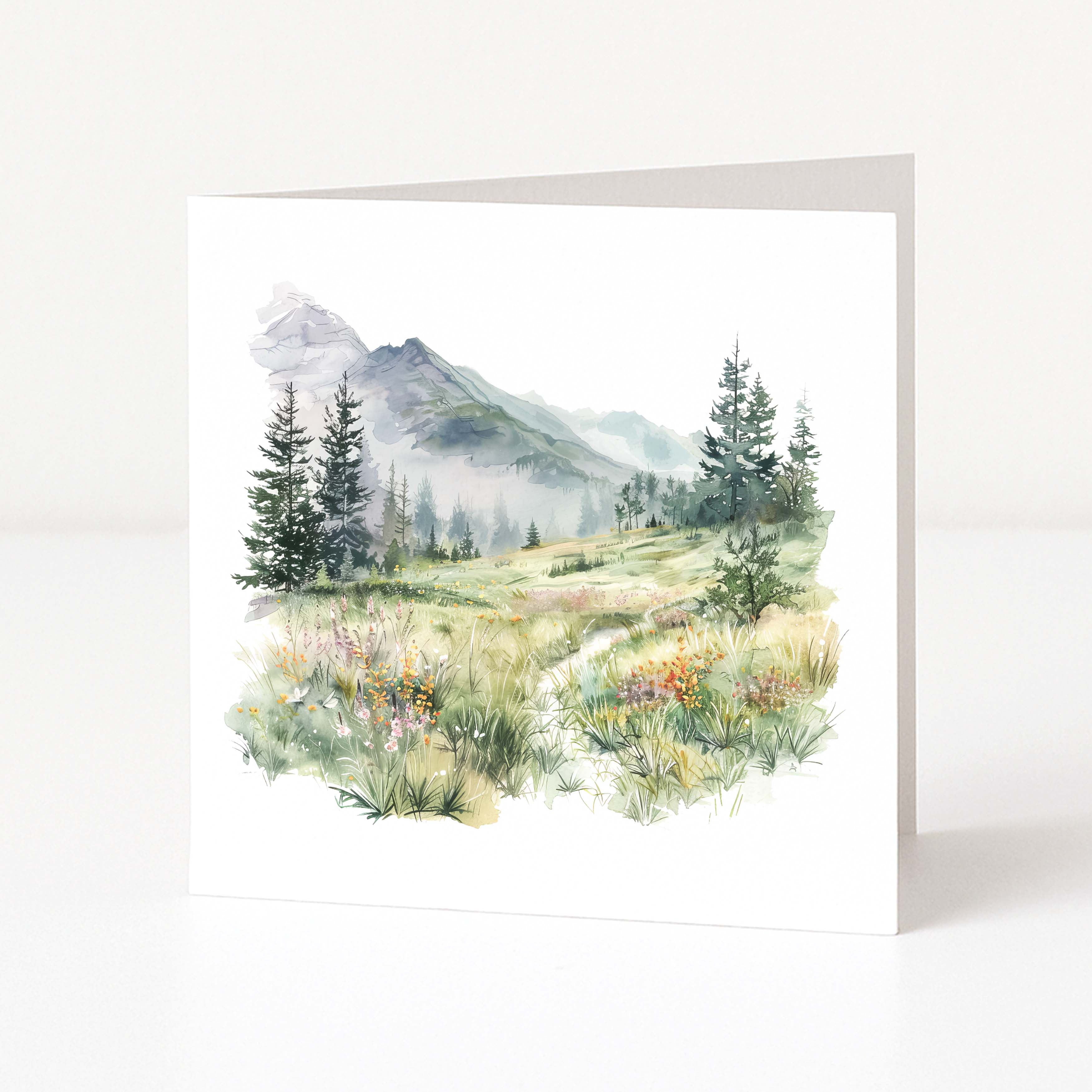 Greeting card with a mountain landscape featuring trees and flowers on a white background