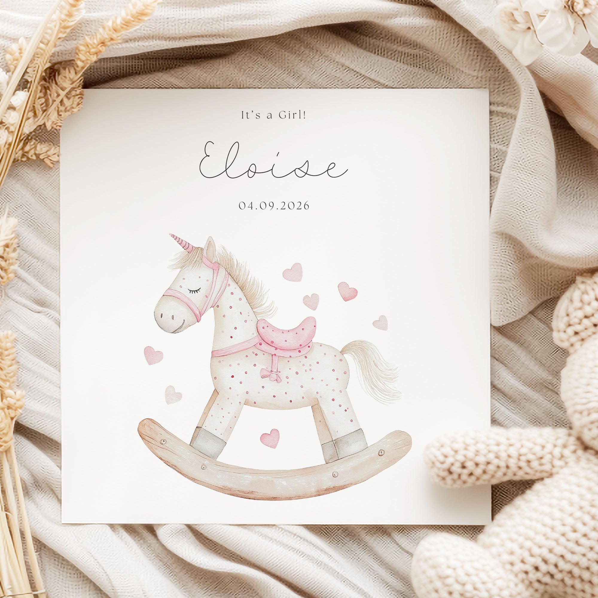 Newborn Baby Girl Personalised Card on linen fabric with dried leaves and rocking horse artwork