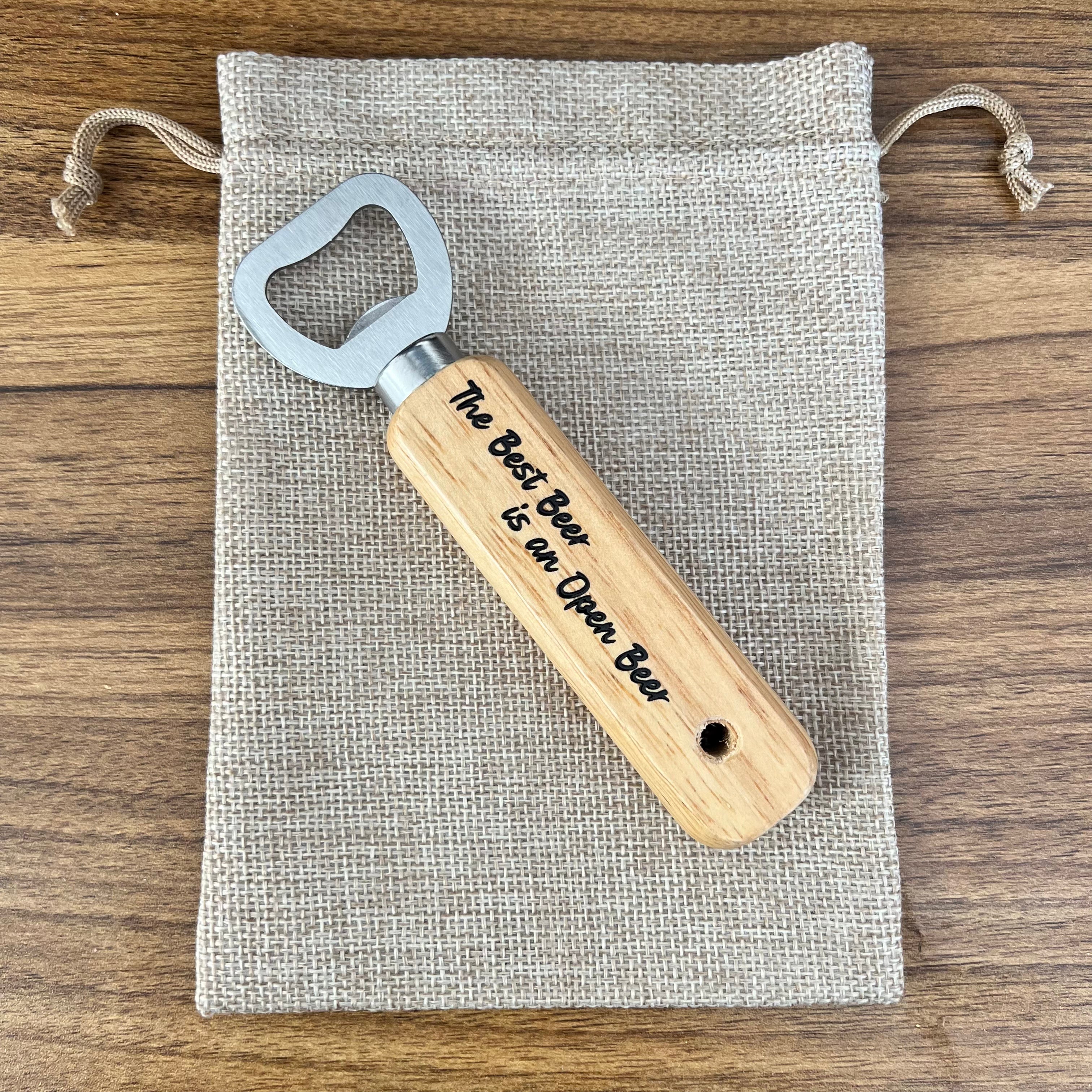 Wooden bottle opener with engraved text on a fabric pouch