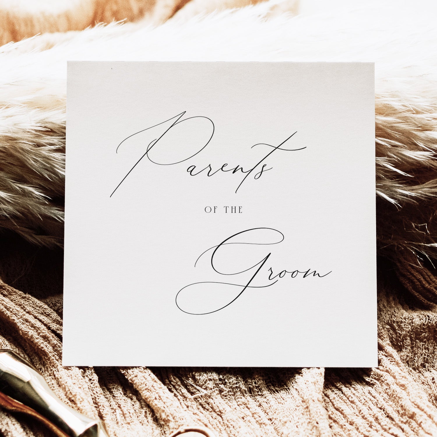 Card with 'Parents of the Groom' text on a textured surface