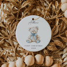 Decorative ceramic ornament with a teddy bear illustration and text on a textured background