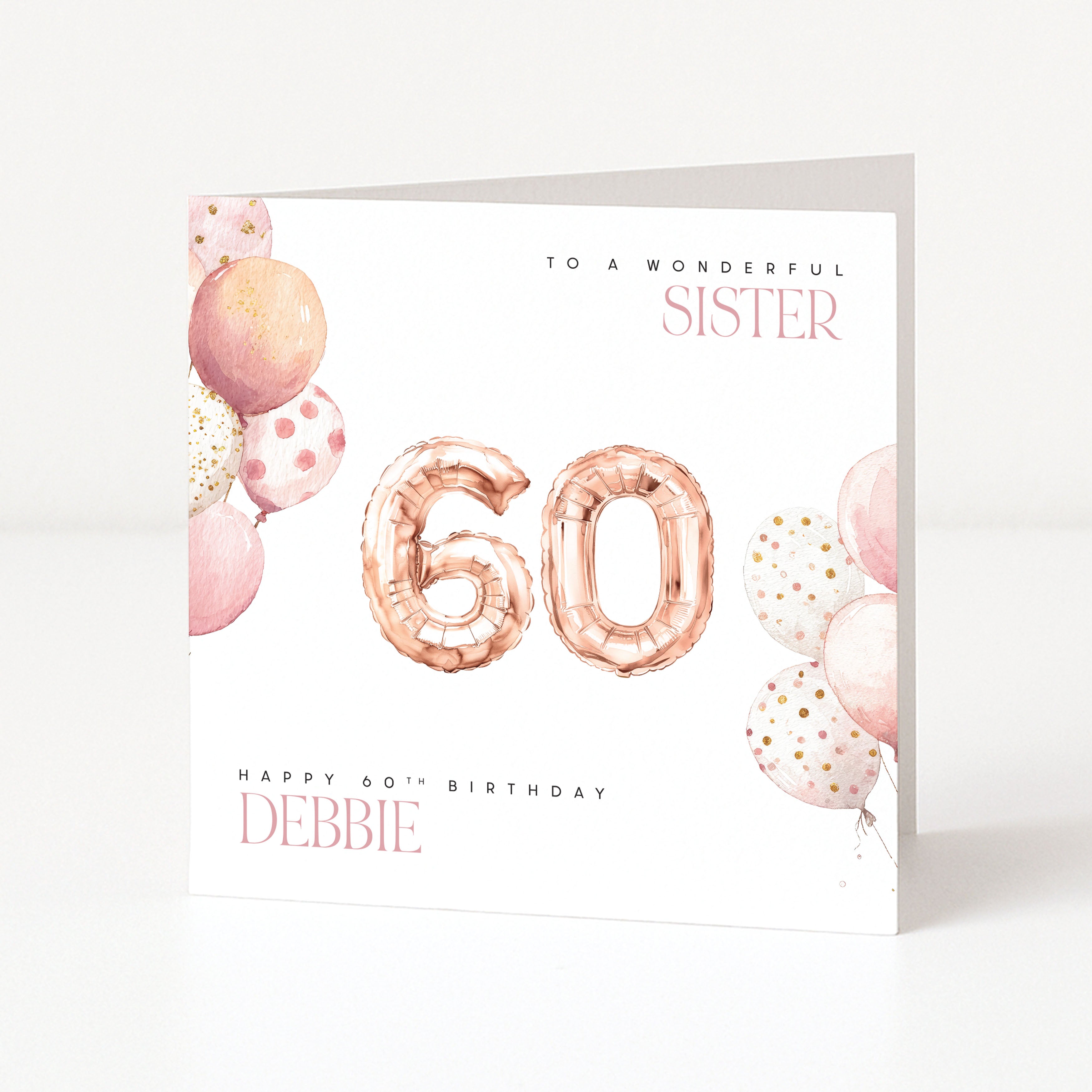 Personalised 60th birthday card for a sister with pink balloon illustrations, rose gold number balloons and custom name.