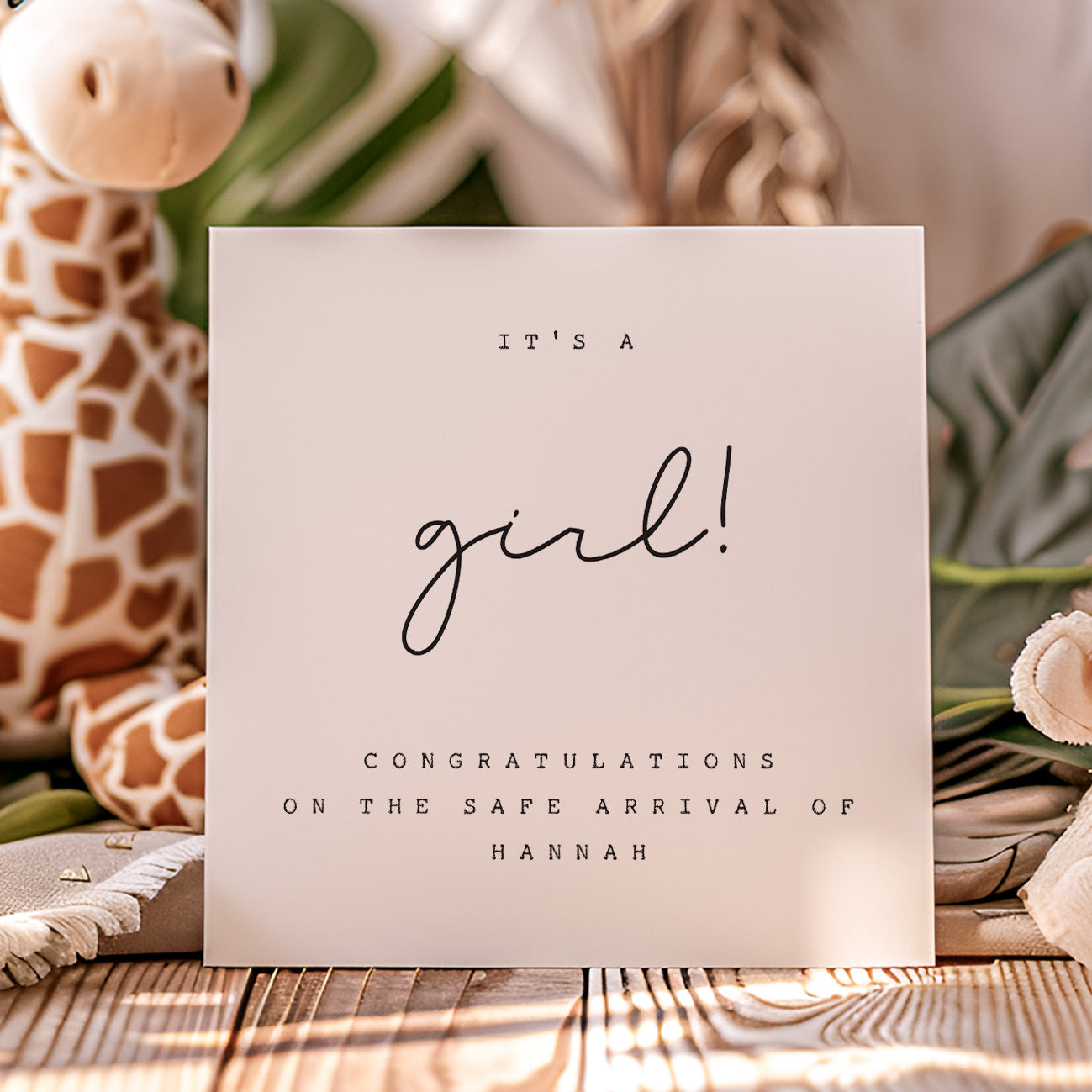 New Baby Card 'It's a girl!' with personalized message, surrounded by baby-themed decor.