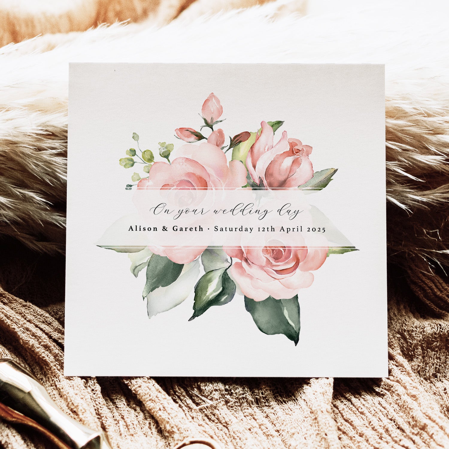 Wedding invitation card with floral design on a textured surface