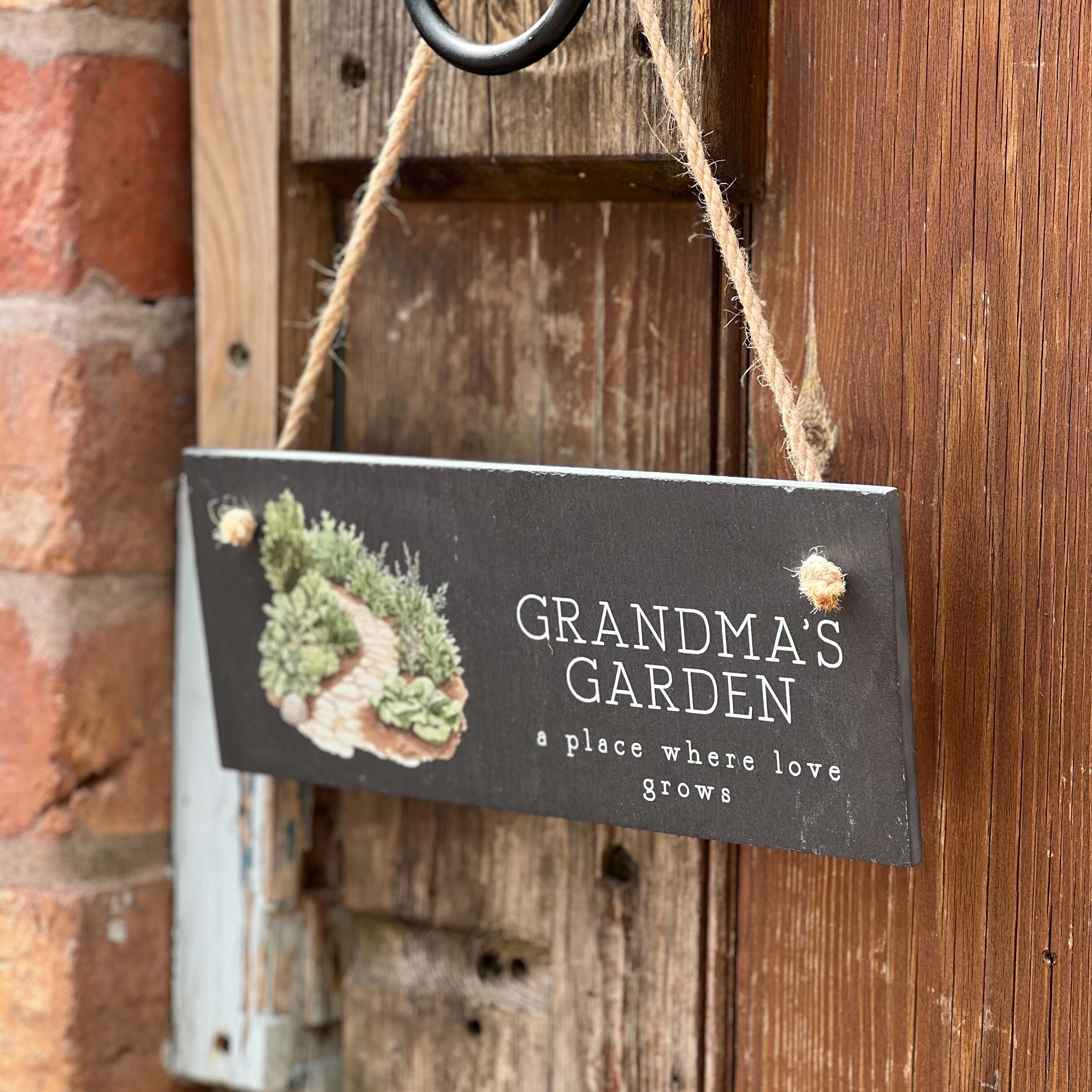 Decorative sign hanging on a wooden door with 'Grandma's Garden' text.