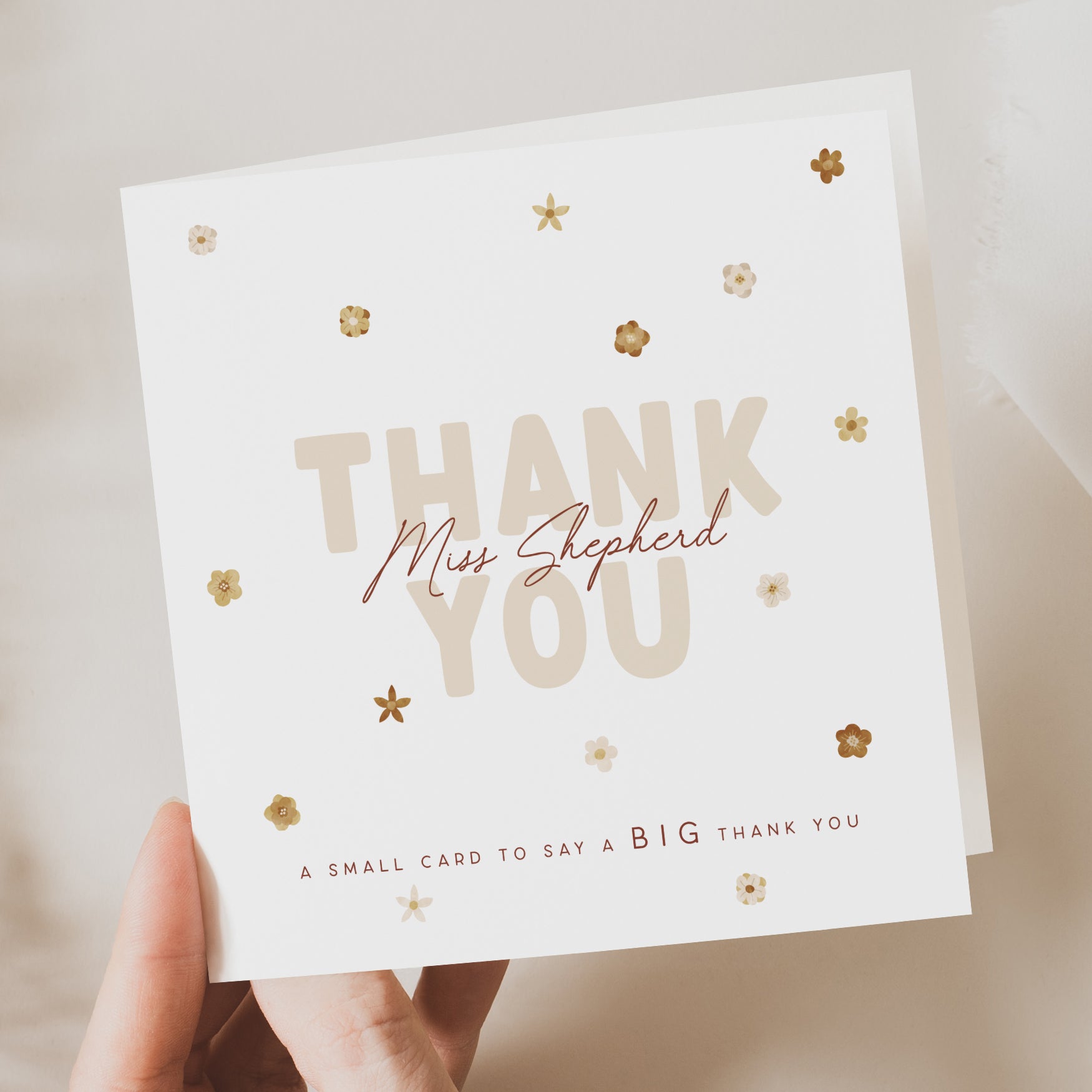 Card with 'Thank you' message and decorative elements held by a hand