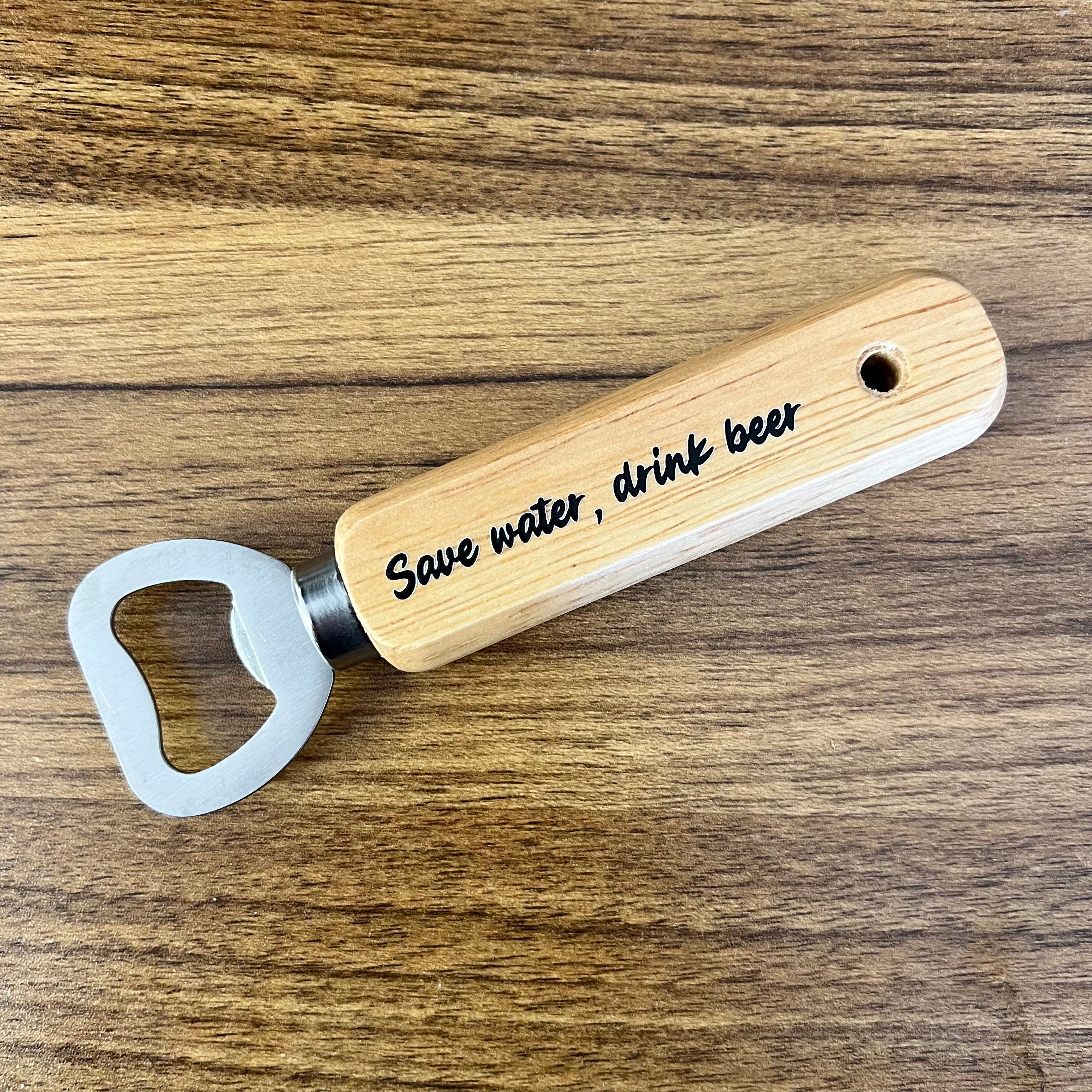 Wooden bottle opener with 'Save water, drink beer' text on a wooden surface
