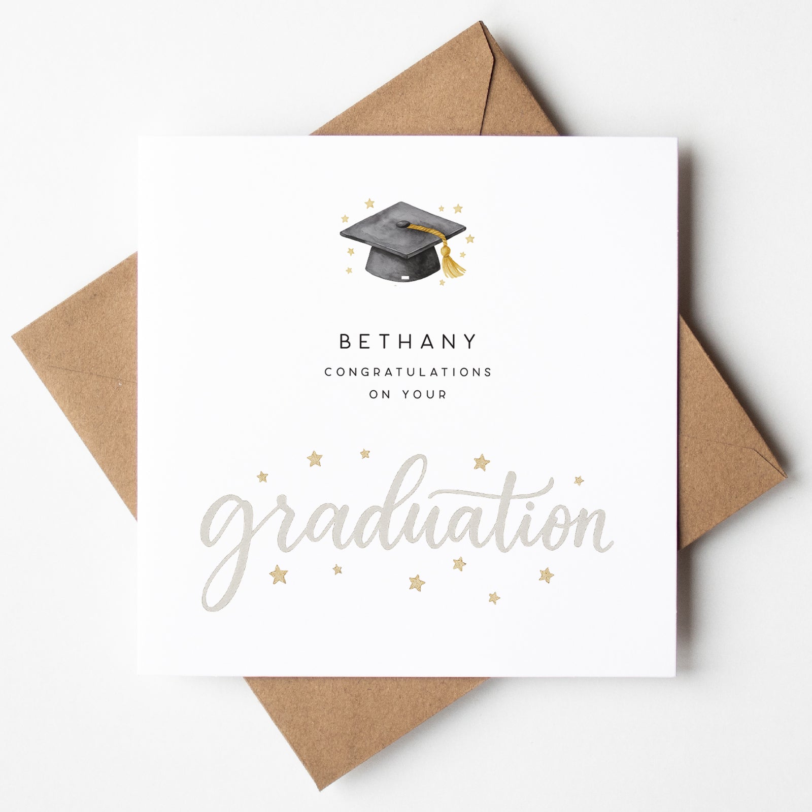 Graduation-themed card with a brown envelope on a white background