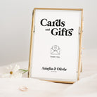 Framed sign with 'Cards and Gifts' text and a heart icon, on a light background.