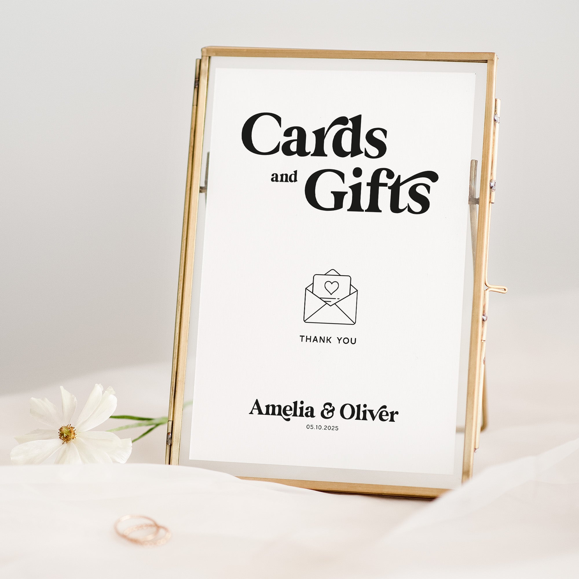Framed sign with 'Cards and Gifts' text and a heart icon, on a light background.
