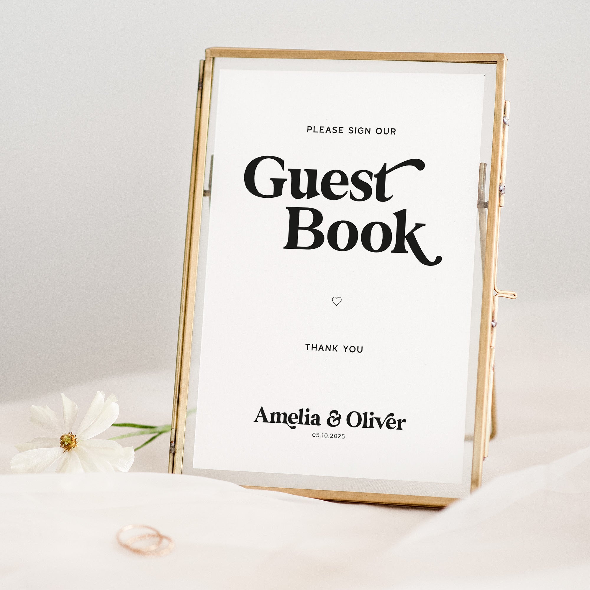 Gold-framed sign that reads 'Please sign our Guest Book' with personalized names and date.