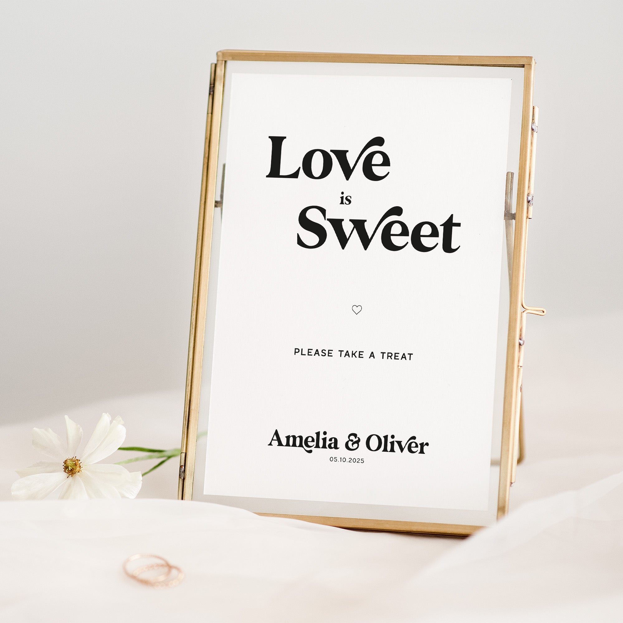 Framed wedding sign with 'Love is Sweet' text on a white background
