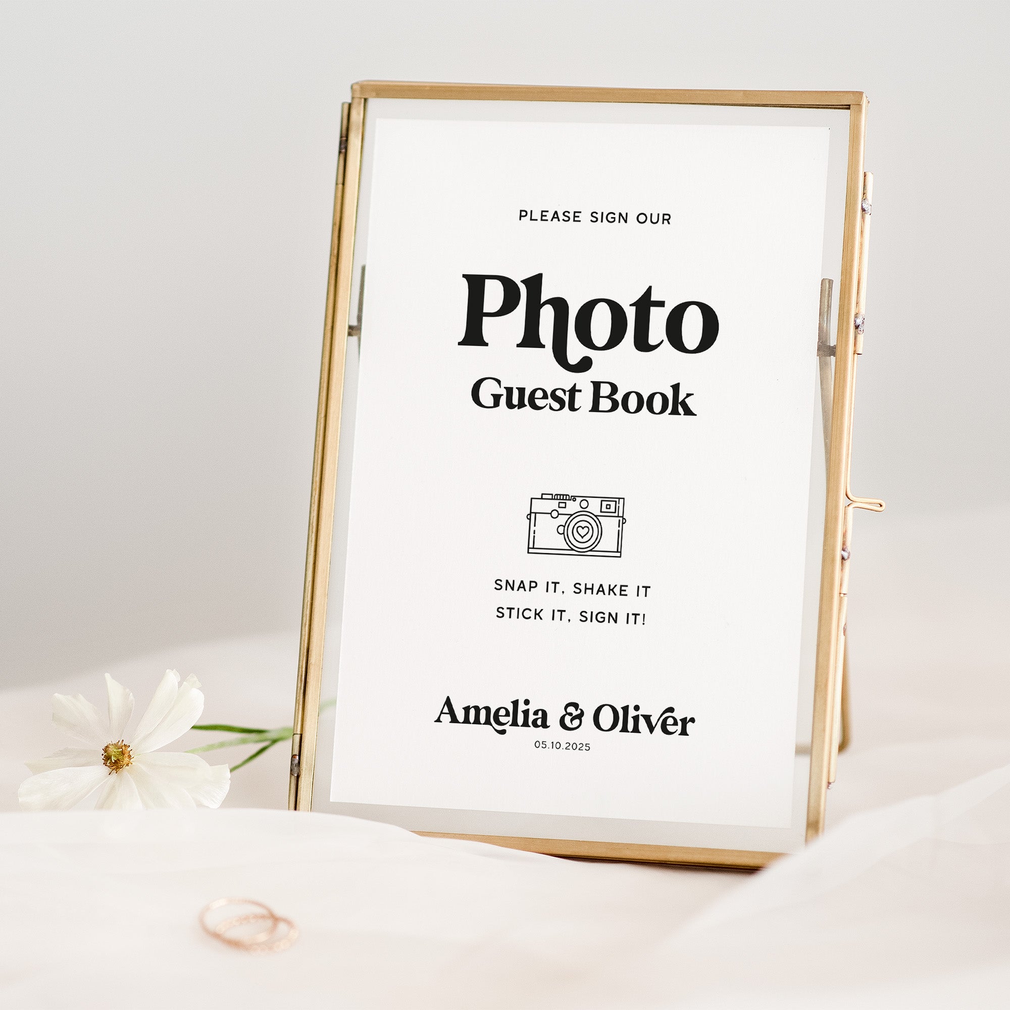Gold-framed photo guest book with text on a white background