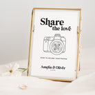 Framed print with 'Share the love' text and QR code for photo upload, on a light background.