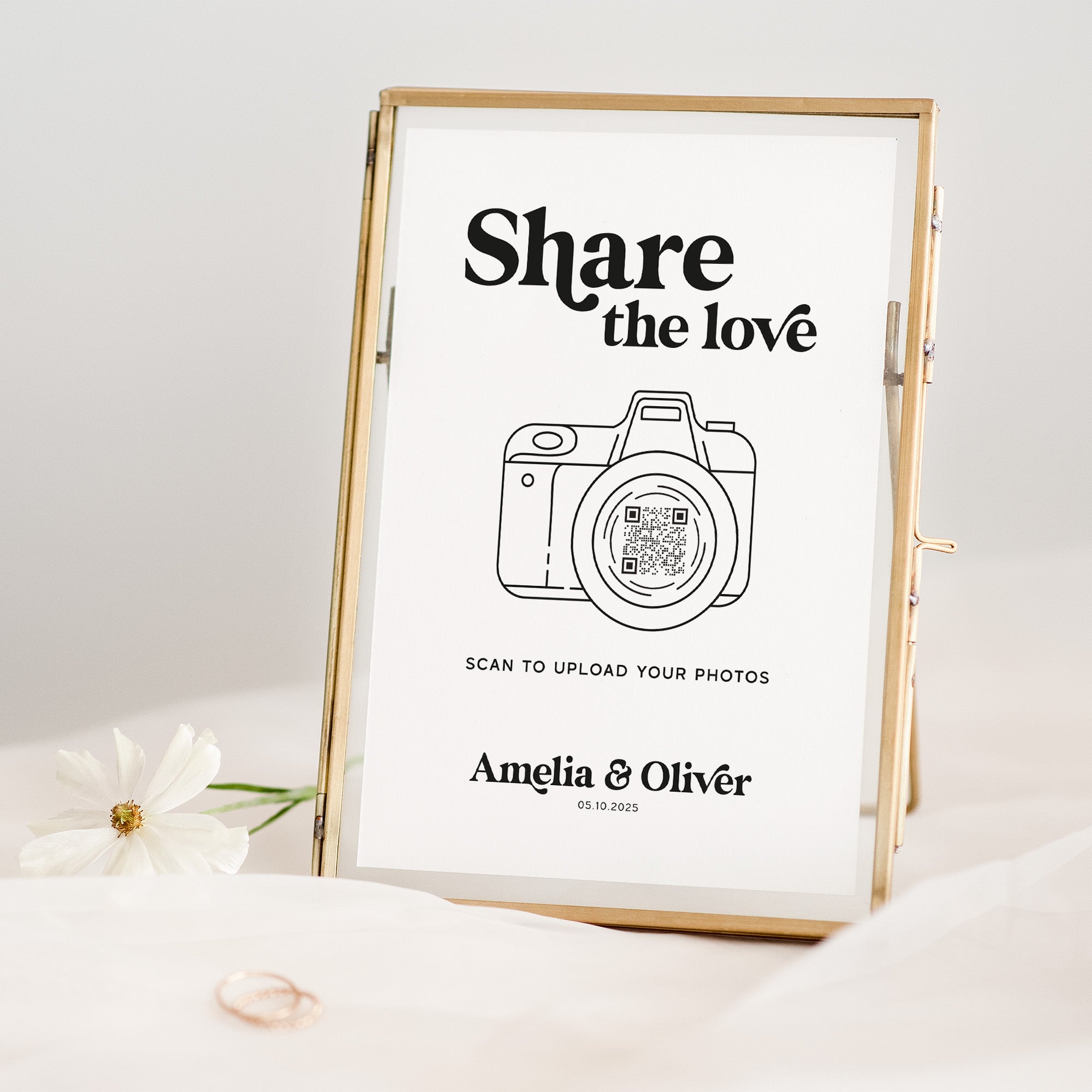 Framed print with 'Share the love' text and QR code for photo upload, on a light background.