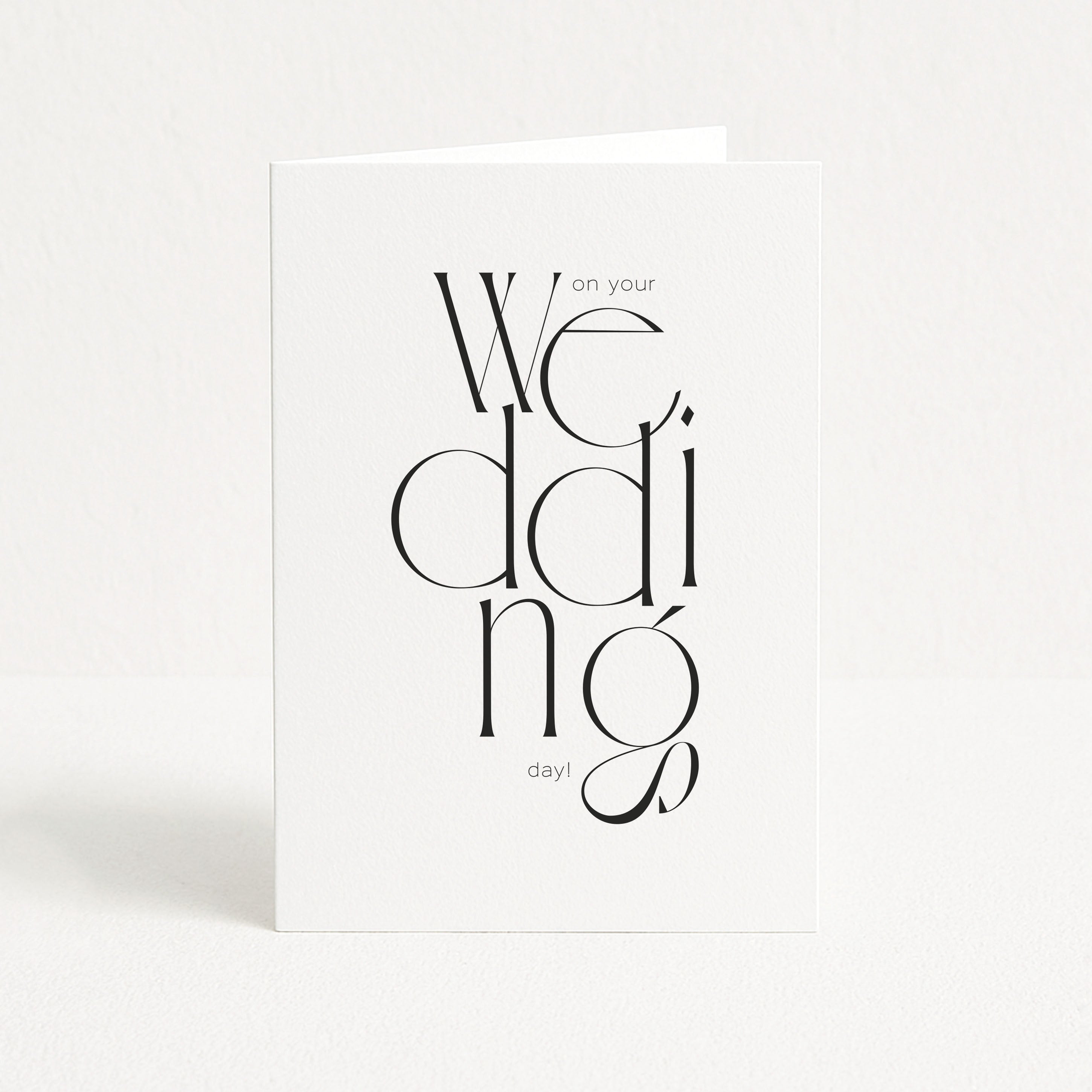 White card with black text 'We do on your wedding day!' on a white background