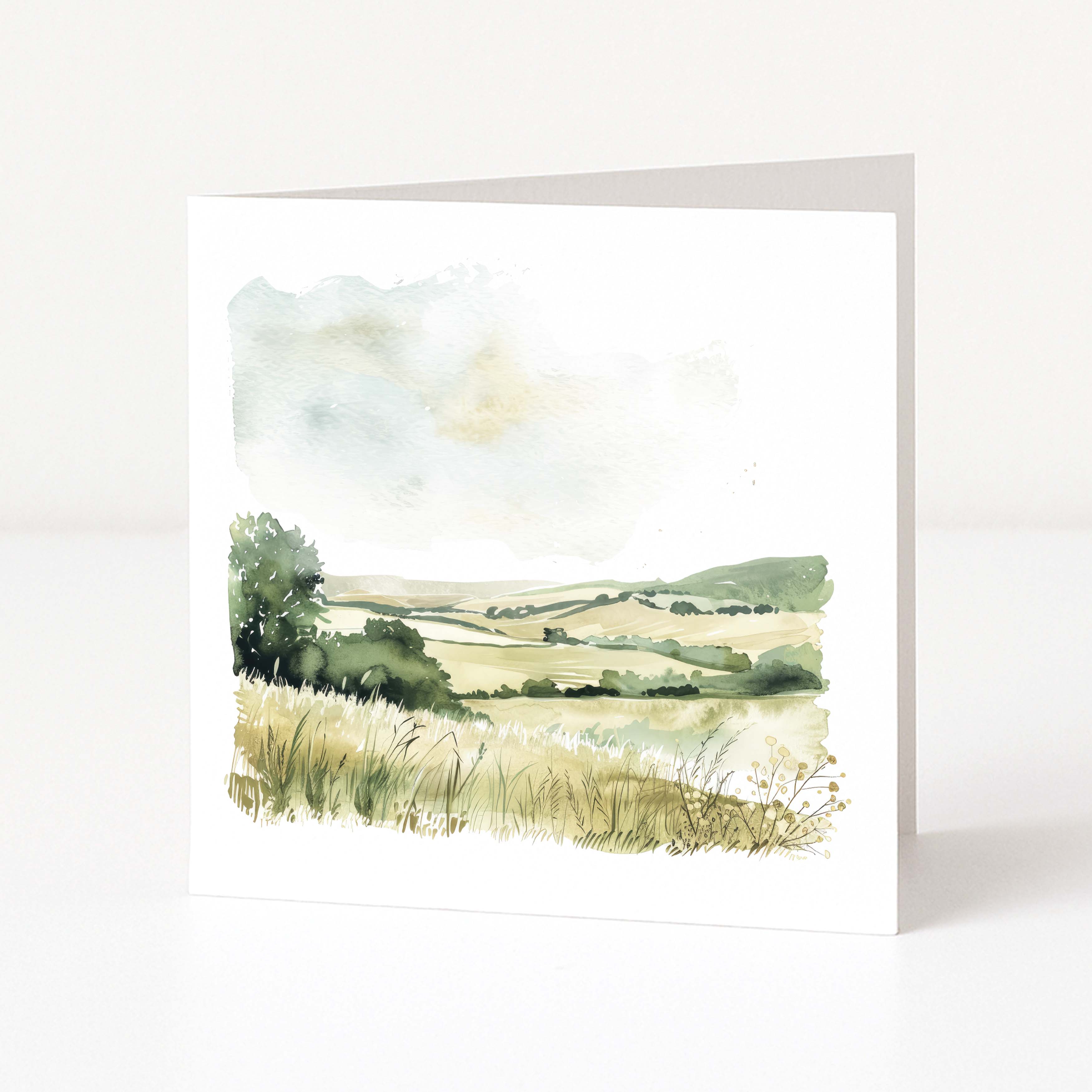 Framed watercolor landscape painting of a field with trees and a sunset.