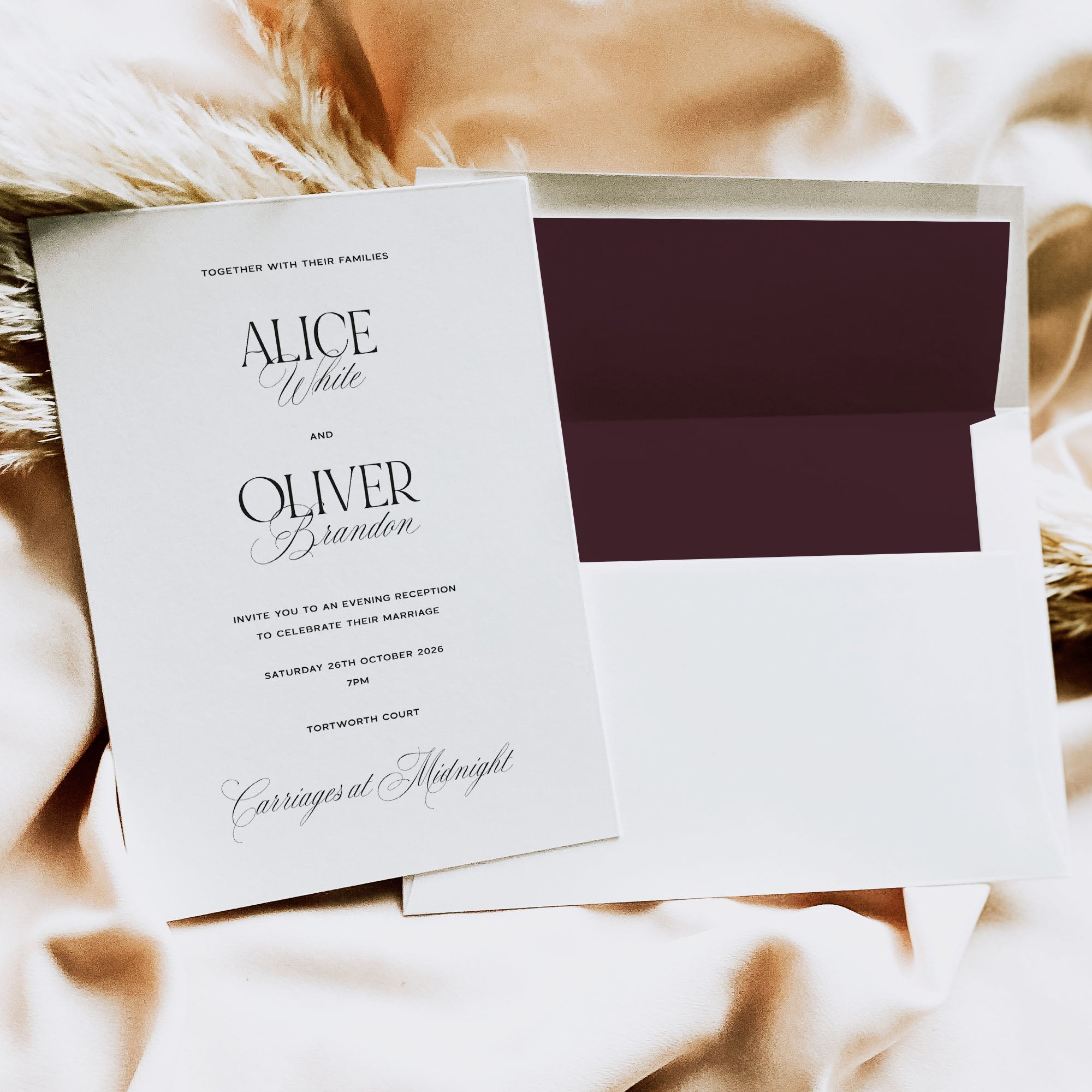 Wedding invitation card with a dark purple envelope on a textured surface